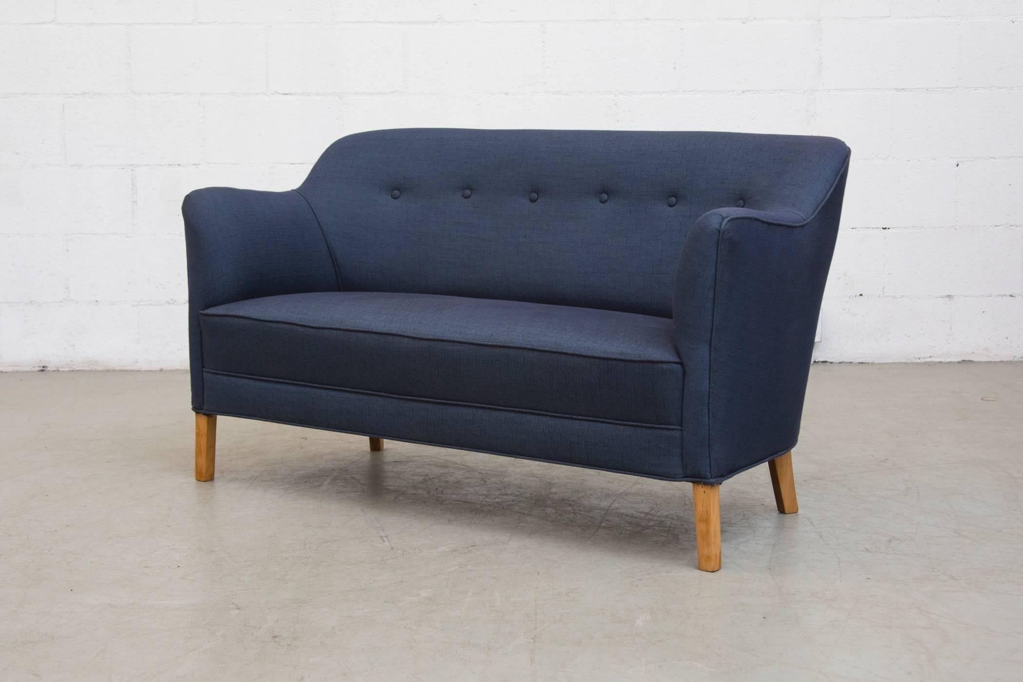 Sweet little indigo blue upholstered loveseat with birch legs. Newly upholstered.