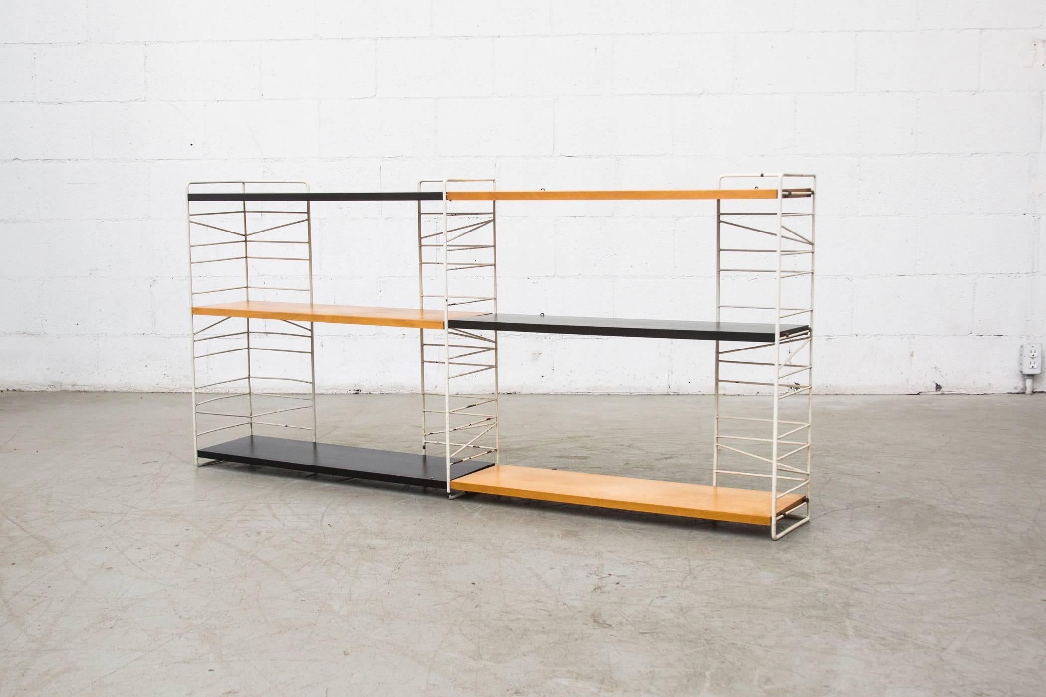 Very versatile birch and black shelving unit with original white coated wire frame. Shelves are in good order, lightly refinished, while the frame is extremely original and visibly worn and peeling.
