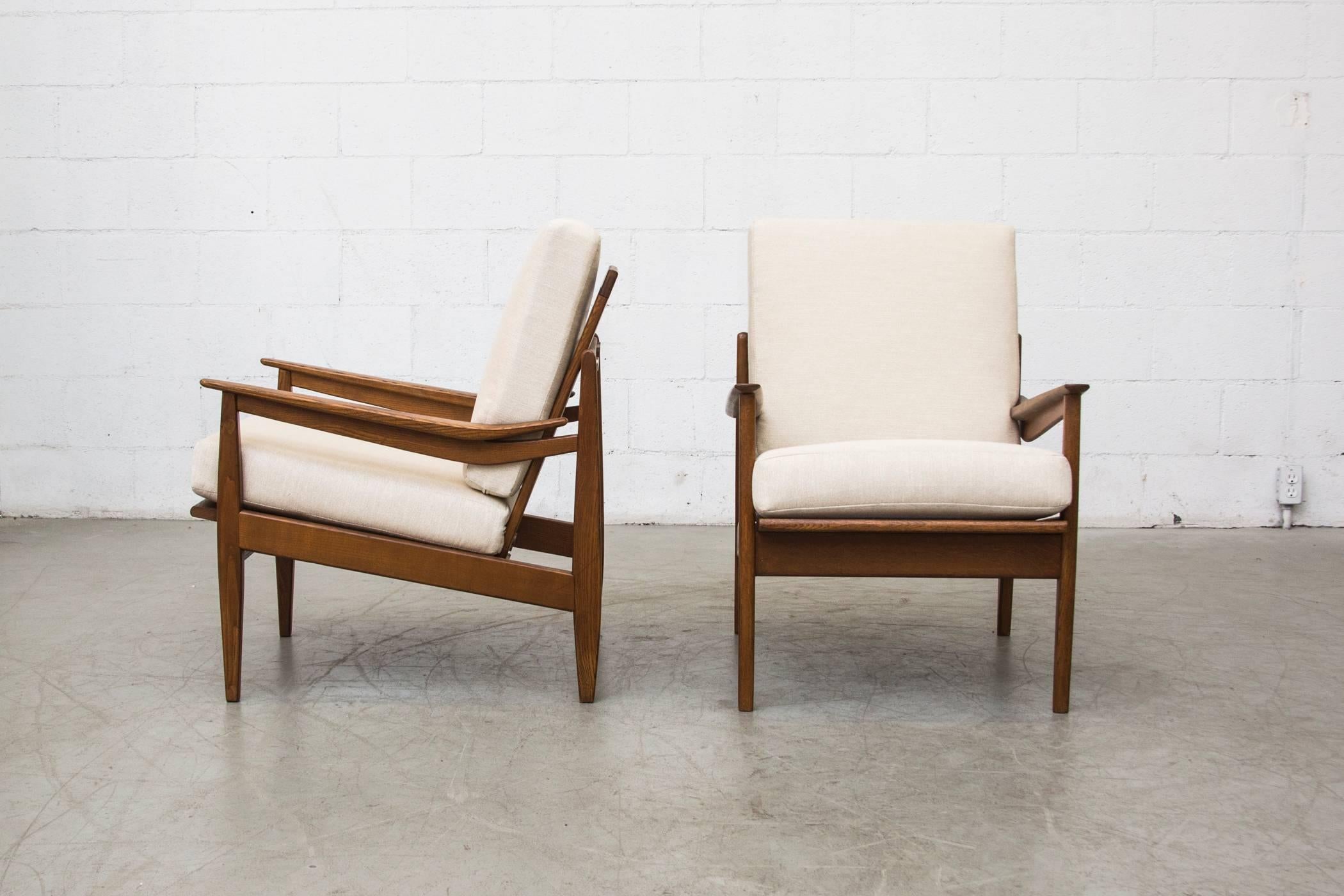 Mid-Century Modern oak framed Danish lounge chairs with new bone upholstery. Good original condition. Set price.