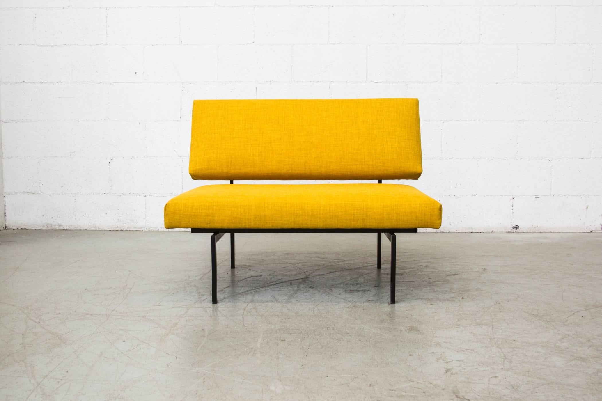 Very rare Coen de Vries loveseat newly upholstered in sunshine yellow. Black enameled metal frame in original condition with visible signs of wear.
