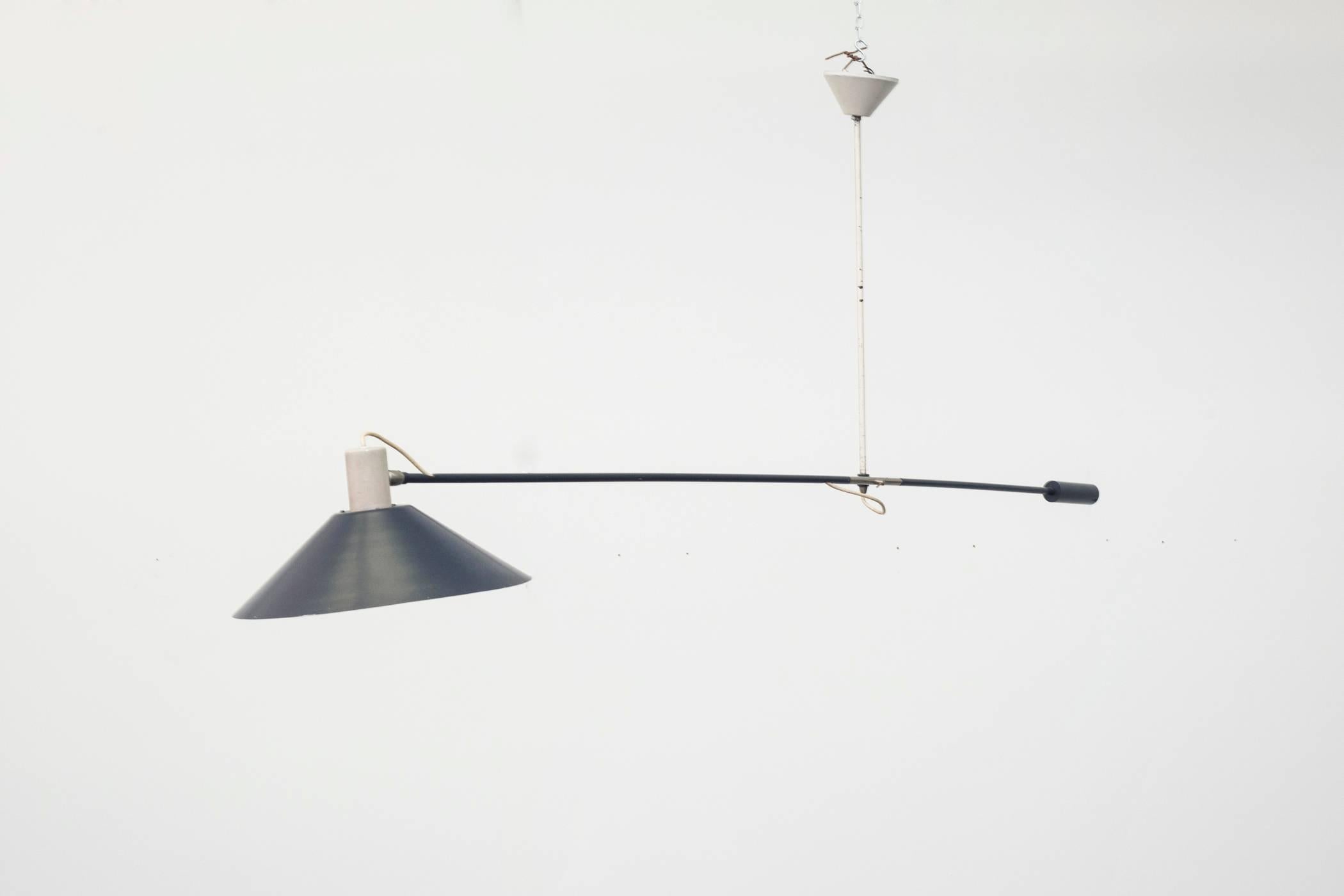 Rare enameled metal counter weight ceiling mount light in charcoal grey. The handle is weighted to help adjust the pitch of the light and can be fastened in place. Visible wear, some chipping. Very original condition. An earlier version is also