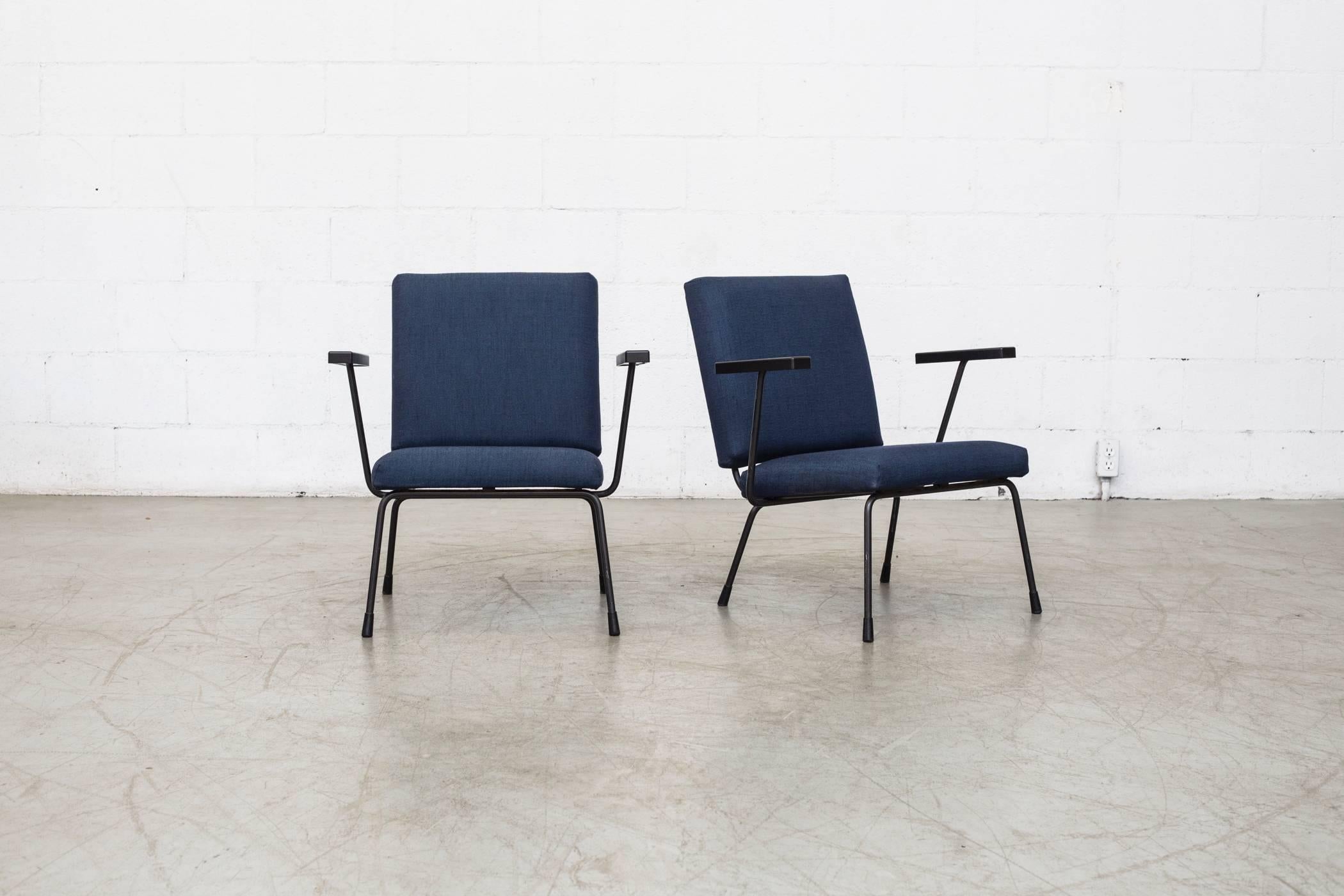 Black enameled steel frame with bakelite armrests. Newly reupholstered in navy. Good original condition. Set price. Others available, listed separately.