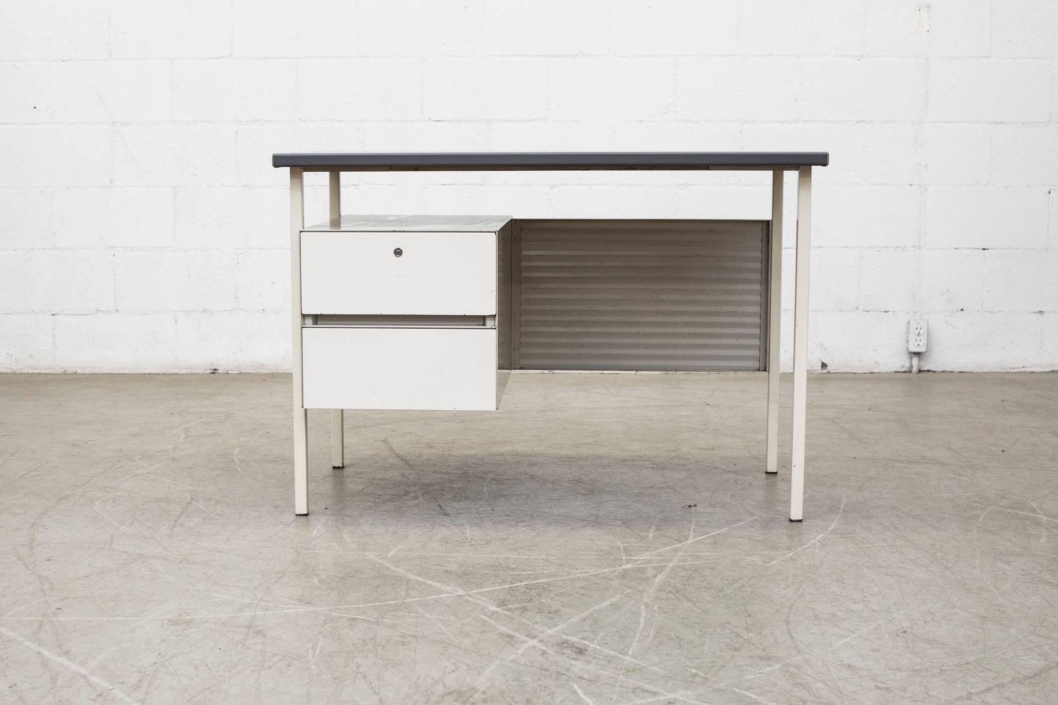 Gispen model 3803 by A.R. Cordemeijer. Cute little light grey enameled metal desk with matching enameled grey corrugated privacy screen and charcoal linoleum top. Original condition with some wear to metal frame consistent with age and use.