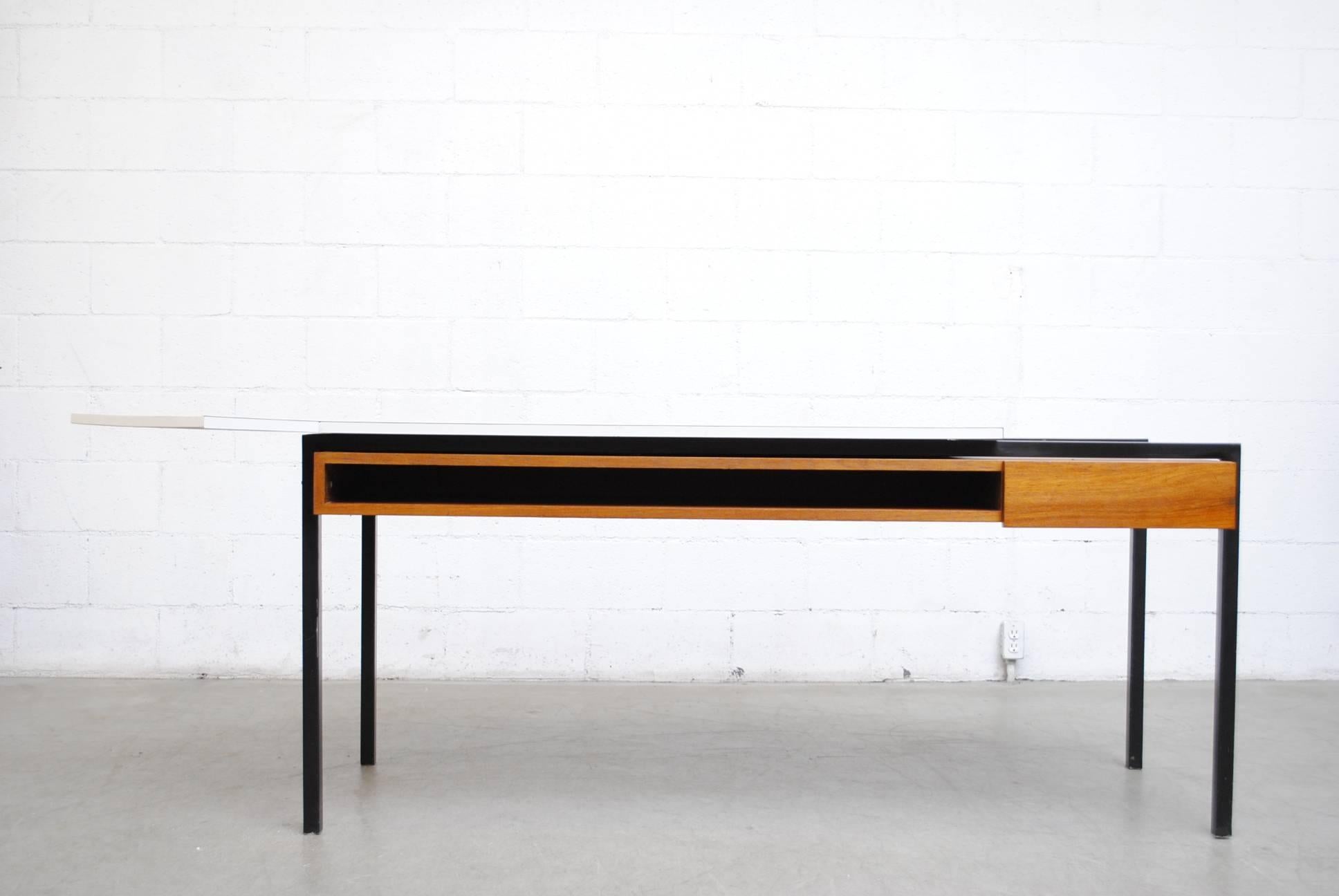 Amazing! Formica topped teak and enameled metal framed desk with stealth storage shelf and right-side drawer. Cantilevered architectural top. Designed by Bas Van Pelt in his early years and produced by his wife after his death in the war. Rare and