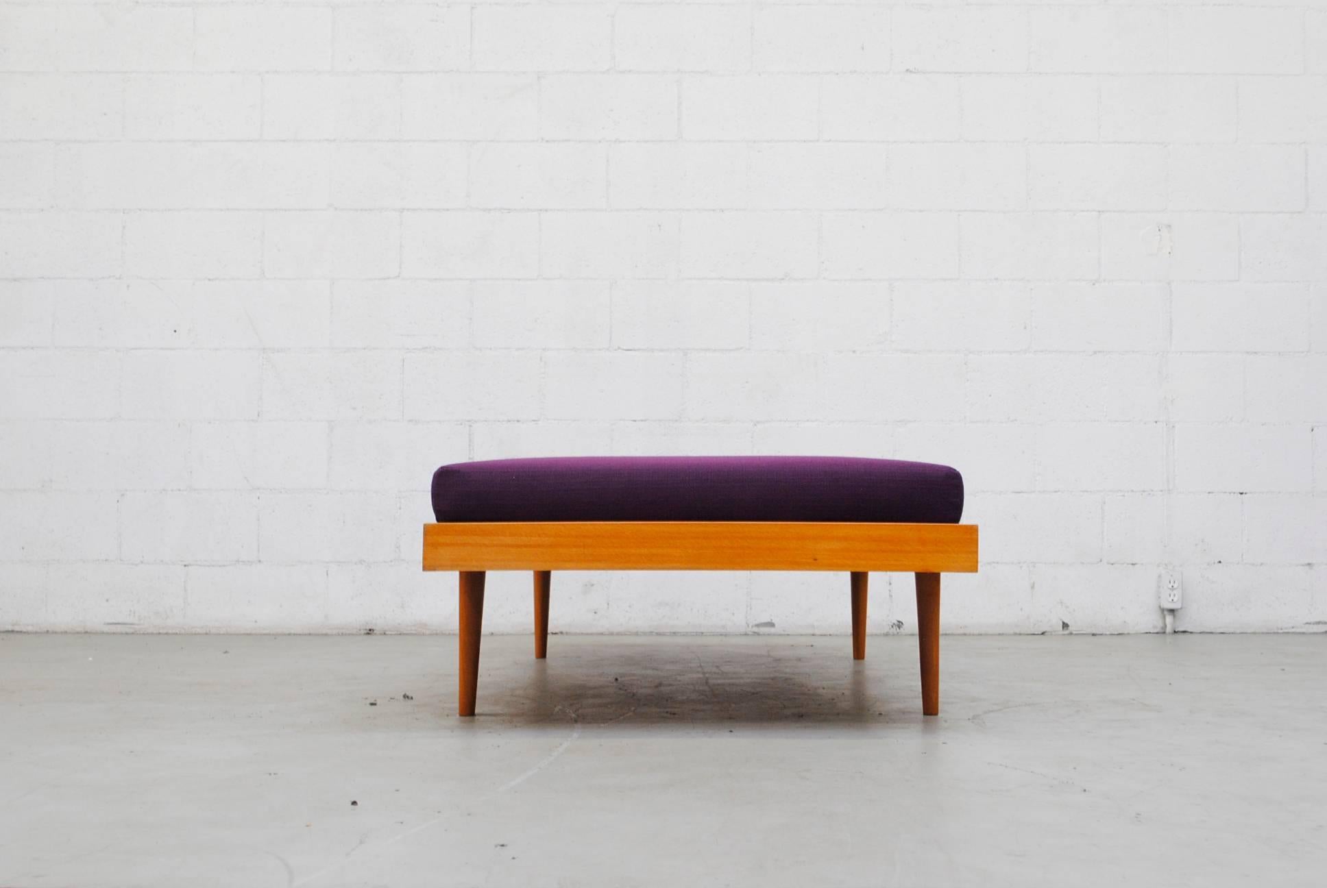 Charlotte Perriand inspired midcentury daybed with tapered legs and new plum mattress. Frame in good original condition with signs of wear consistent with its age and usage.