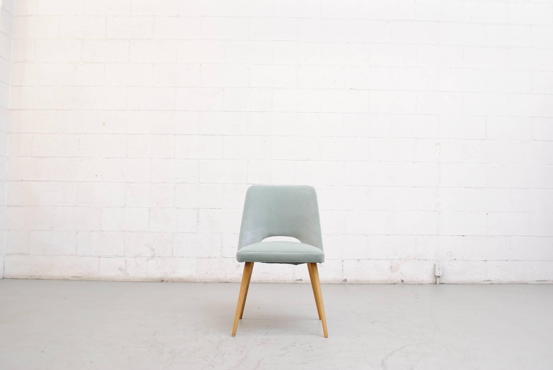 Dutch, mid-century modern dining or cocktail chair. Designed in a style that's very reminiscent of Finnish designing great Eero Saarinen. The chair has handsomely tapered blonde wood legs and has been newly upholstered in lovely teal velvet. In good