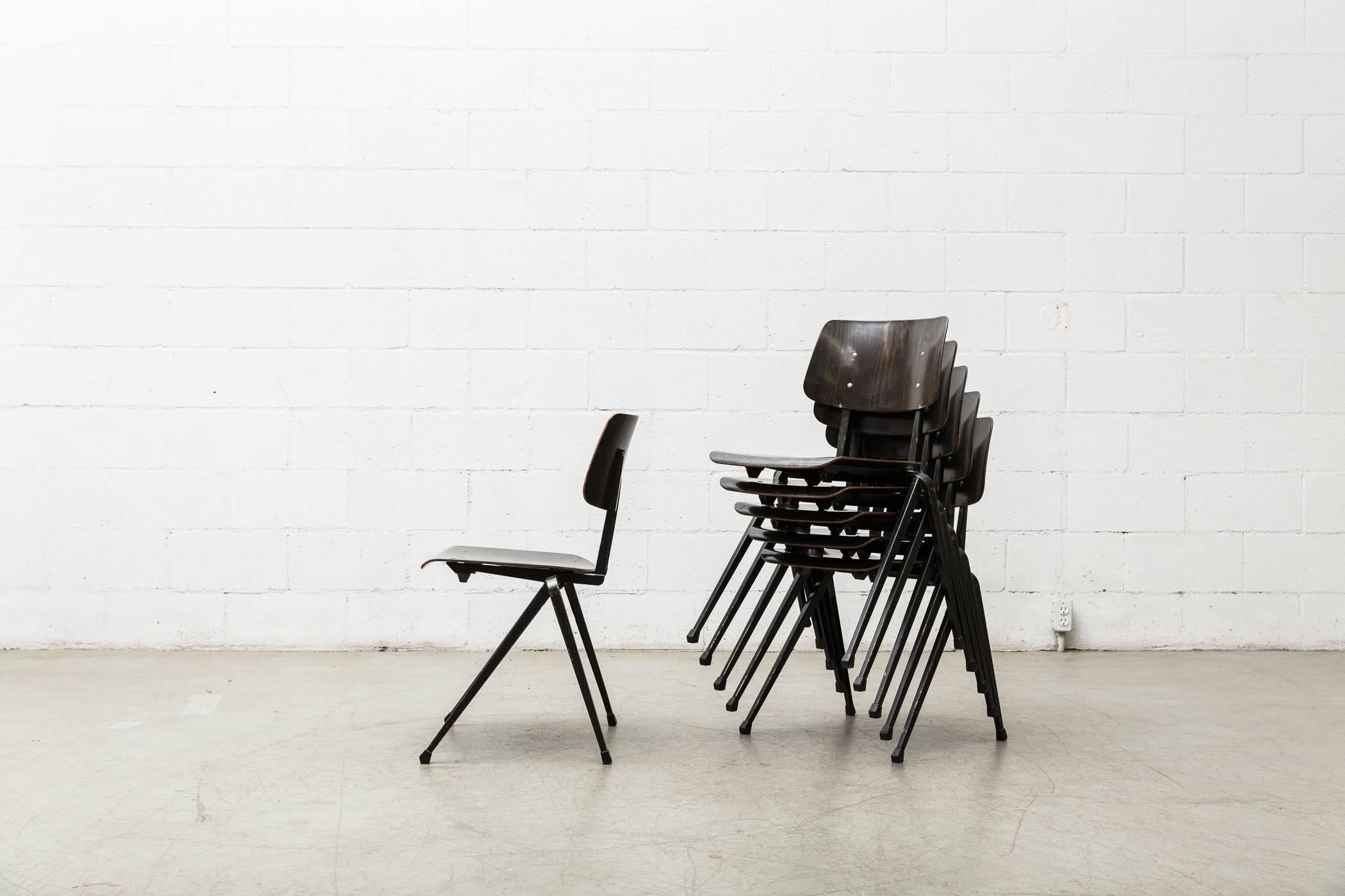 Wenge toned seat and back stacking chairs with espresso brown enameled Prouvé style legs. Slight variations in color. Original condition with visible wear to enamel on frame.