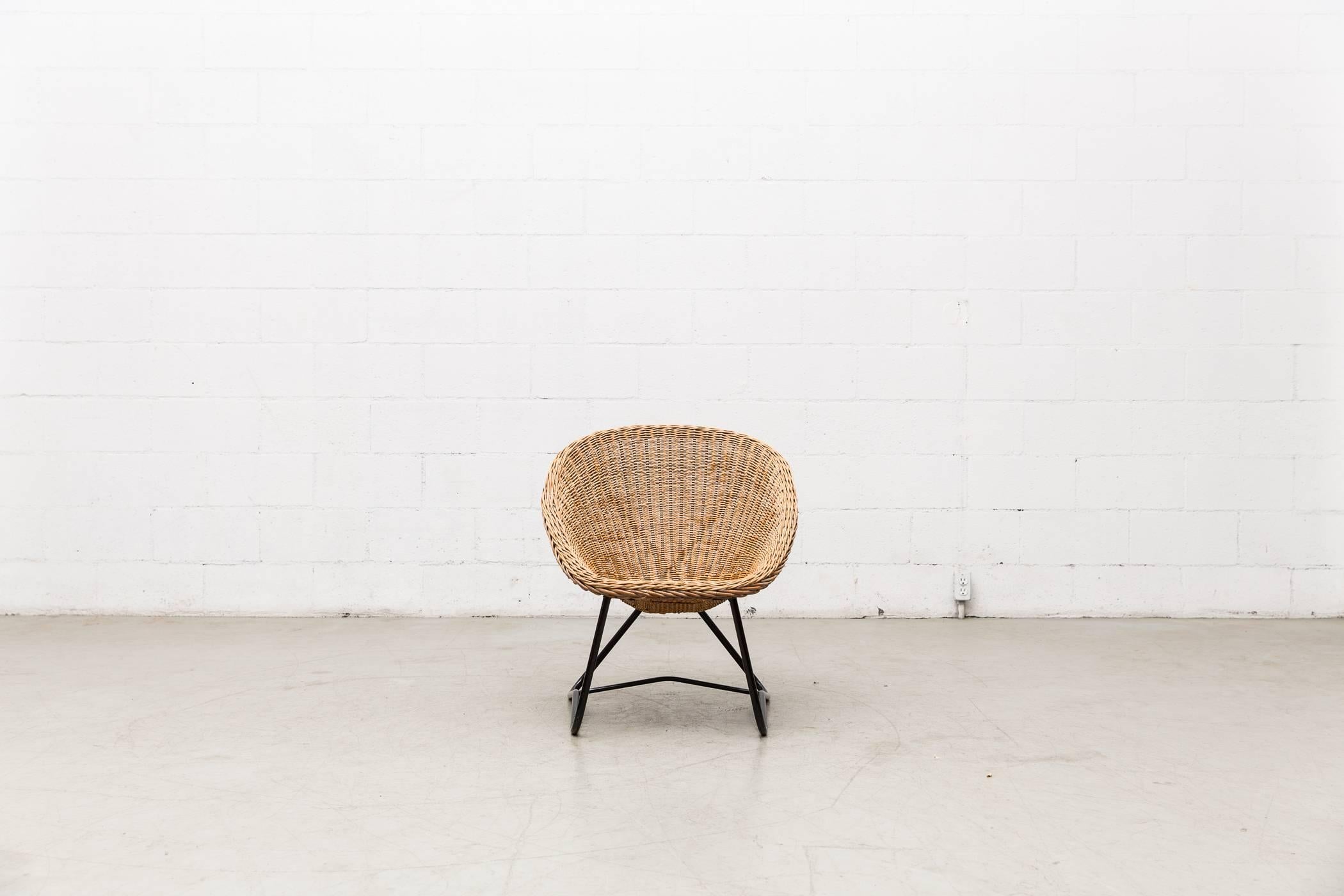 Gorgeous woven rattan bucket chair with black enameled cross frame by Dirk van Sliedregt for Gebr. Jonkers. Excellent condition.