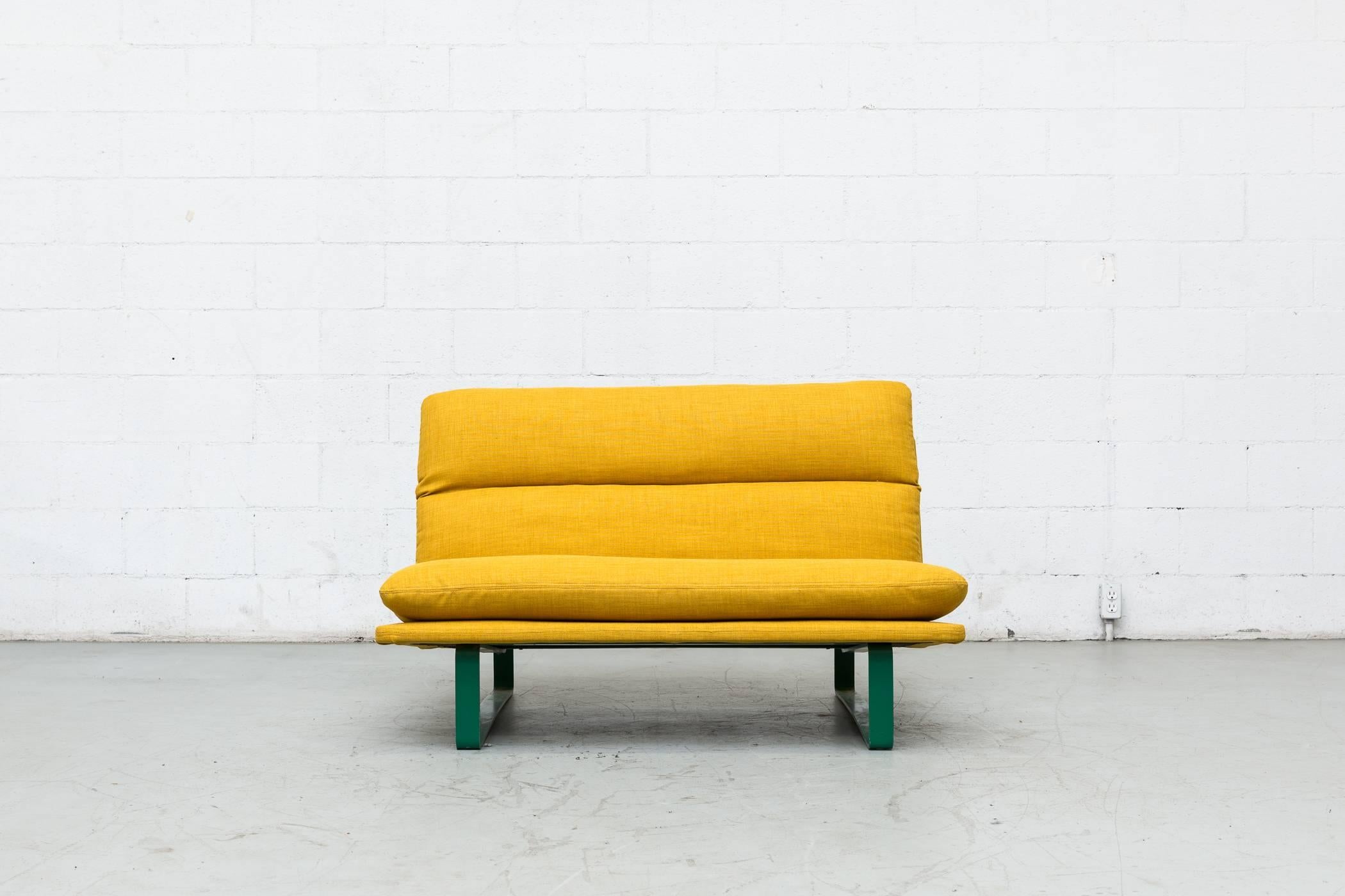 Rare Artifort loveseat with original Kelly green enameled metal base with new sunshine yellow upholstery. Retains original label. Frame in original condition with visible wear.