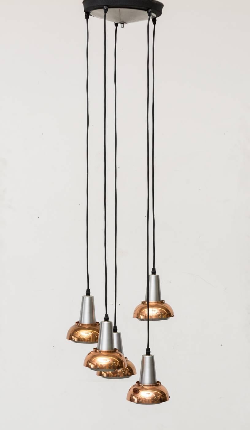Mid-century, 5 pendant hanging chandelier by Lakro Holland , 1960s. Chrome Accents and copper, tiered shades with orange enameled interiors. The piece is in good original condition with minor signs of age appropriate wear.