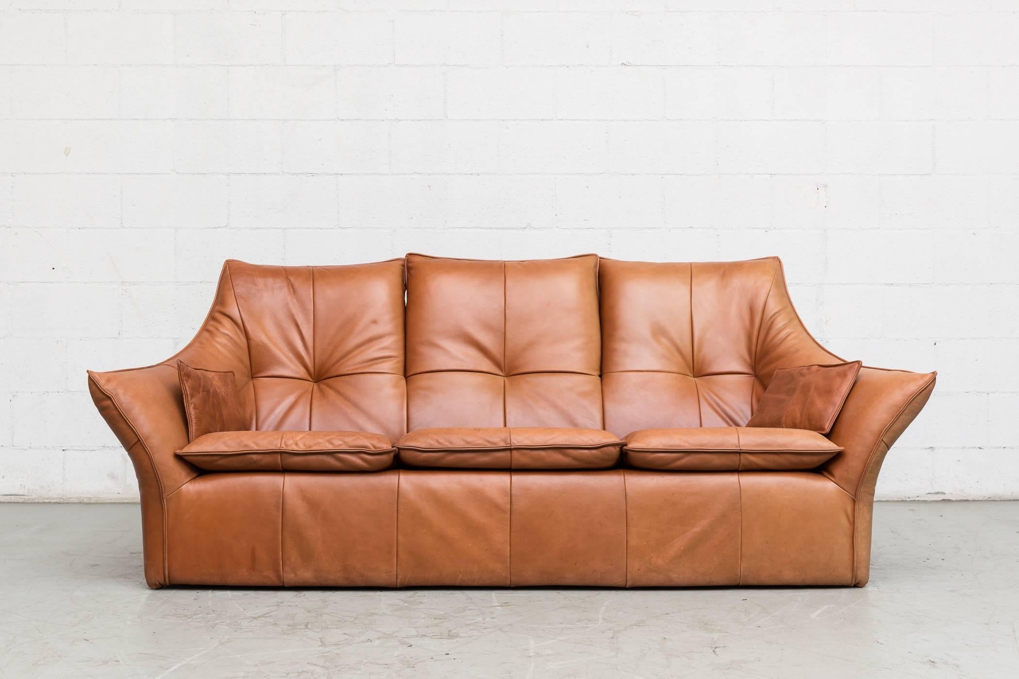 Thick cognac buffalo leather upholstered three-seat "DENVER" sofa by Gerard van den Berg for Montis. Was reupholstered in factory issued leather in the late 1970s. Good original condition front shows slight fading compared to the back.