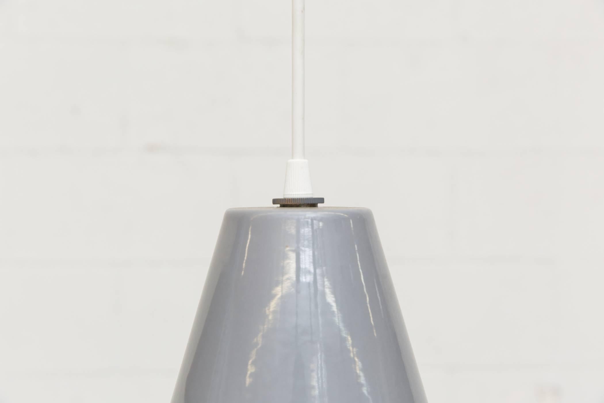 Mid-century, grey enameled metal industrial Dutch factory pendant lamps with white enameled metal interior. Design is similar to the 