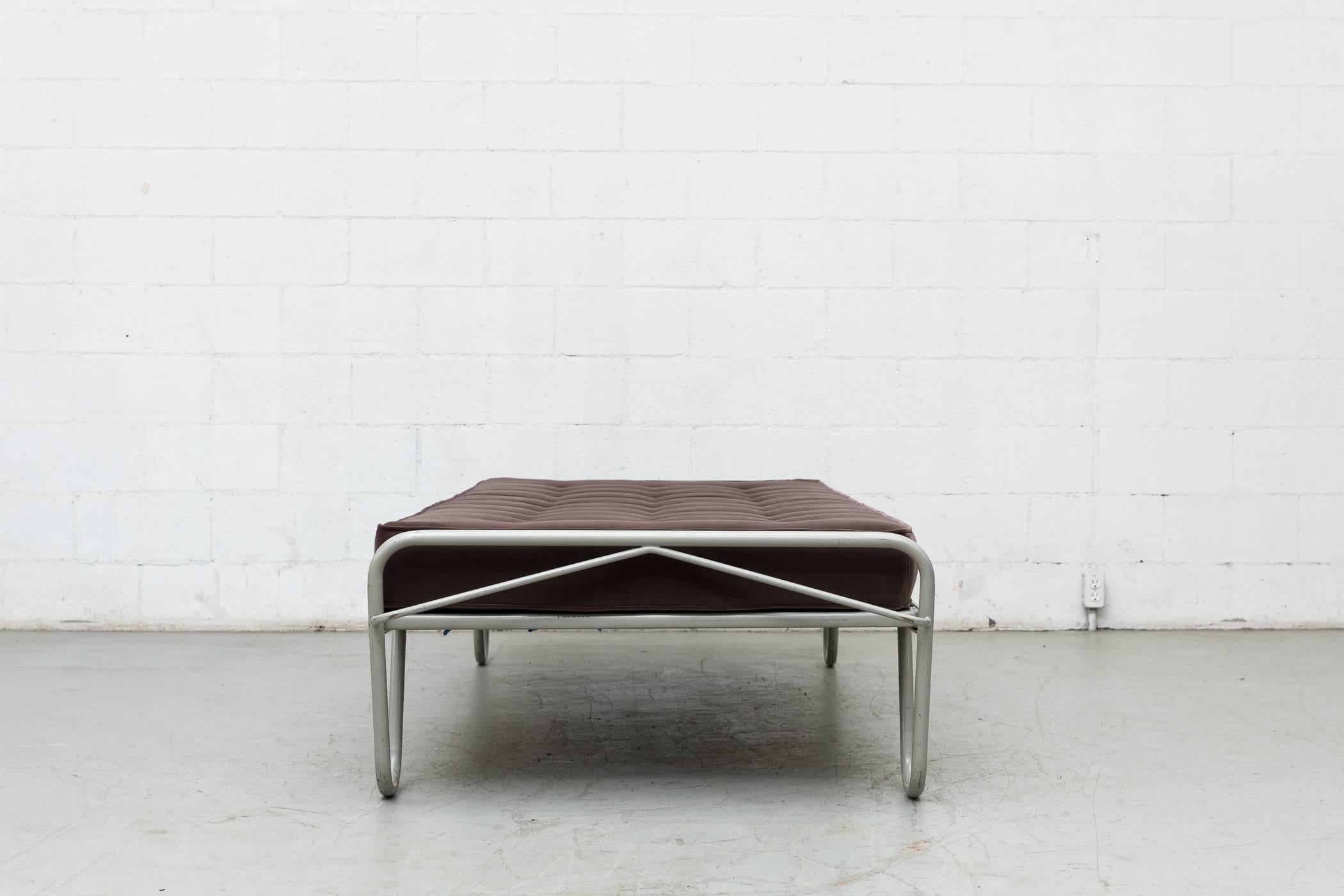 New seal grey tufted velvet mattress on an Institutional grey enameled metal single bed frame by A.R. Cordemeyer and manufactured by Kupers in Almelo, 1950s. The frame is in original condition with visible wear to the enamel. Can be disassembled for