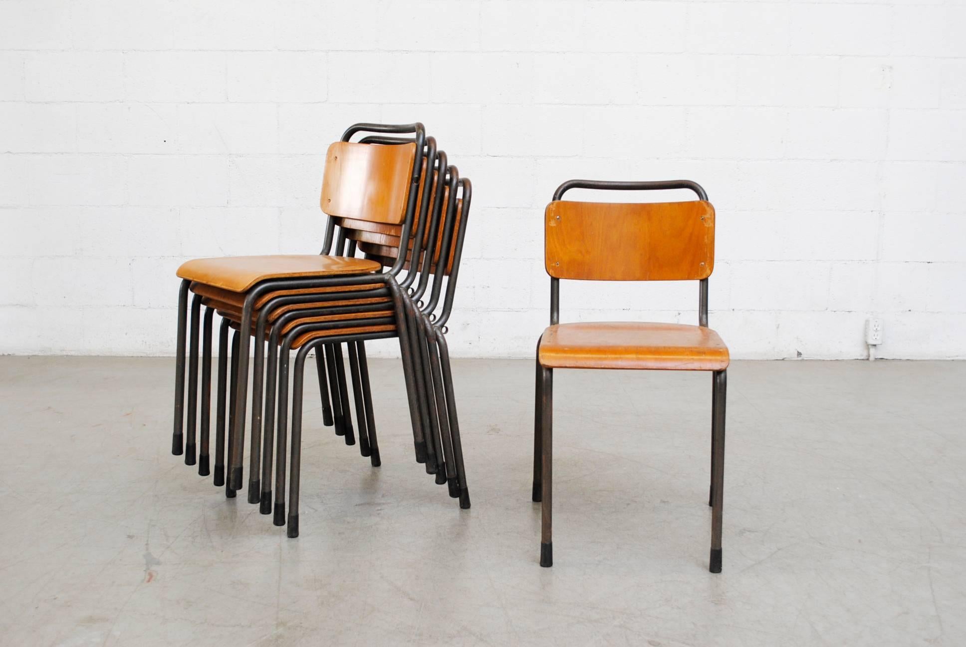 Stackable Industrial school chairs with grey enameled metal frames and molded plywood seats and backs. In very original condition with visible signs of wear, well loved. Nice patina.