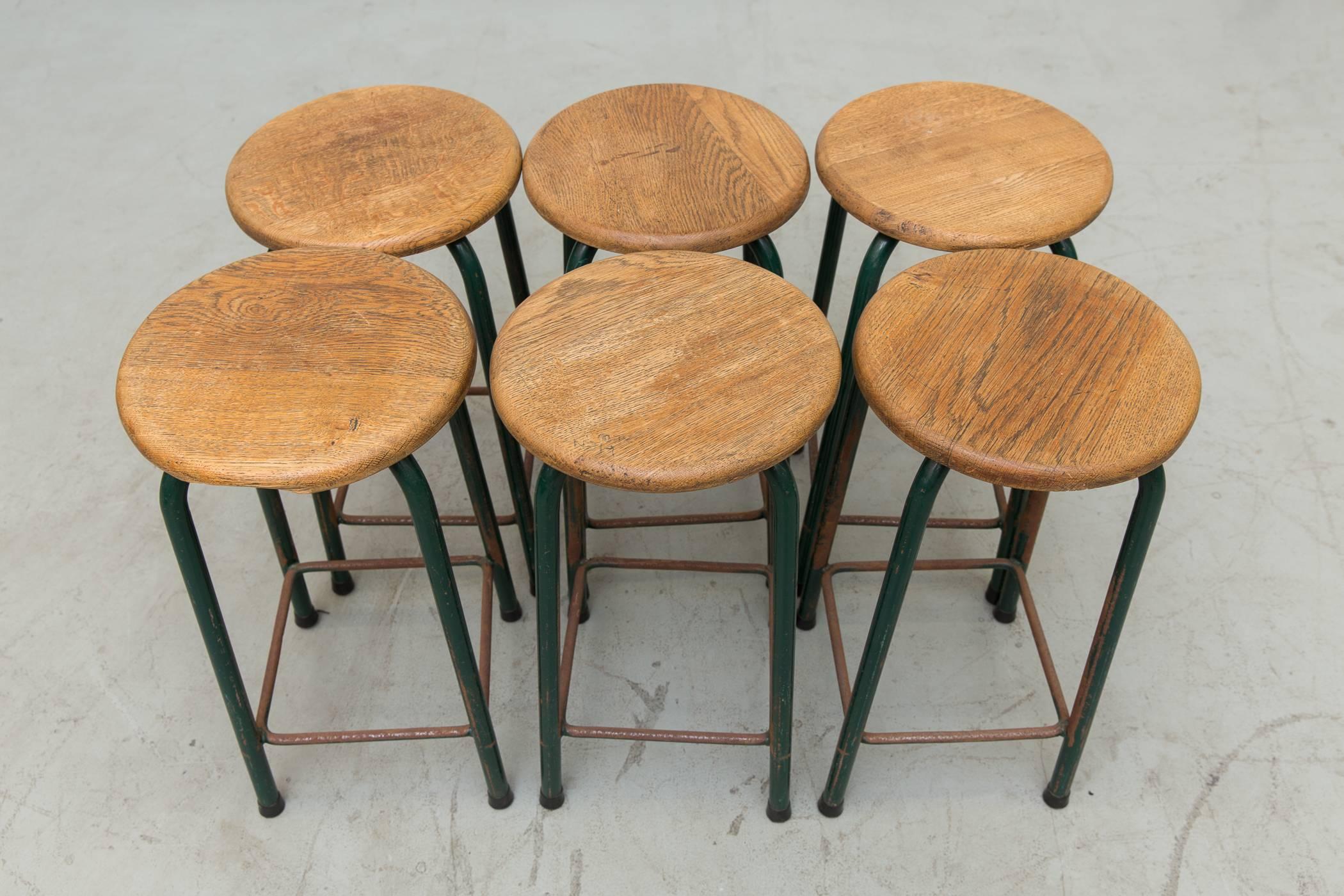 Amazing set of lab stools with solid wood tops and original hunter green enameled metal bases. Original condition, with visible wear and nice patina. Some imperfections in the wood, signs of surface rust. Set price.