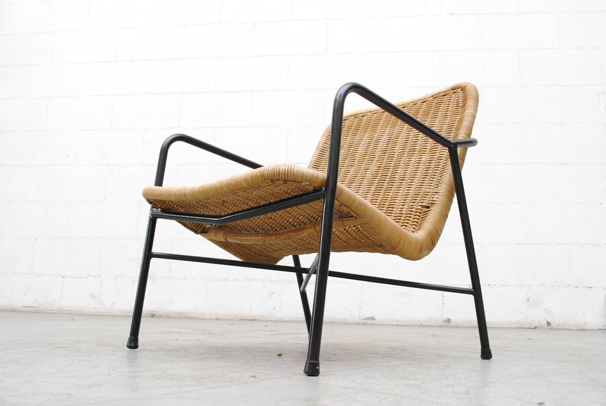 Woven rattan seat on original black enameled metal frame with new leather buckle strap which holds seat to frame, tightening adjusts the seat pitch. Seat and frame in good original condition with wear consistent with its age and usage.
