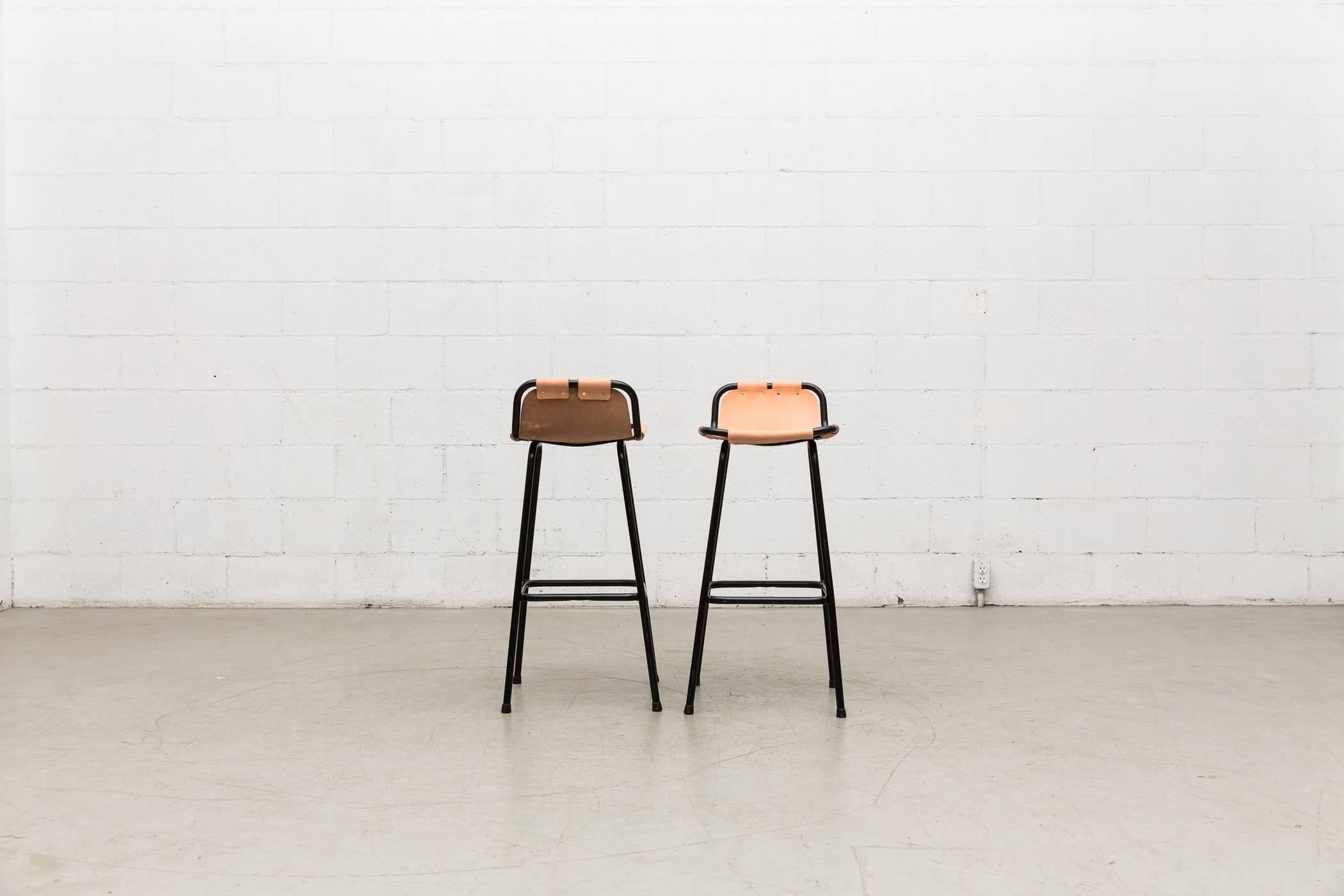 Tall pair of leather and enameled metal Perriand style bar stools. Newly powder coated metal frame with new leather seating, brass rivets. Will patina nicely over time. (See our key chains from Newest to Oldest) Set price.
