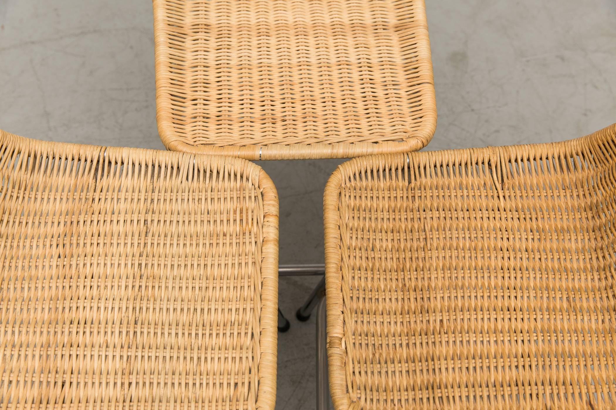 Set of three table height angle backed wicker. Slight variation in coloring. These were once tall bar stools which have since been shortened to table or low counter height. All original condition with visible signs of wear. Chrome in very original