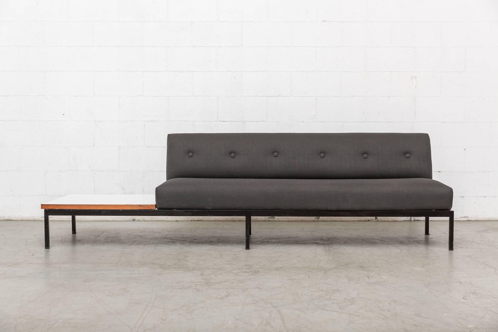 Gorgeous midcentury three-seat Kho Liang Ie sofa for artifort with white formica side table with teak border. Newly upholstered in grey fabric with black enameled metal frame. Table and seating can be oriented to either left or right side of sofa.