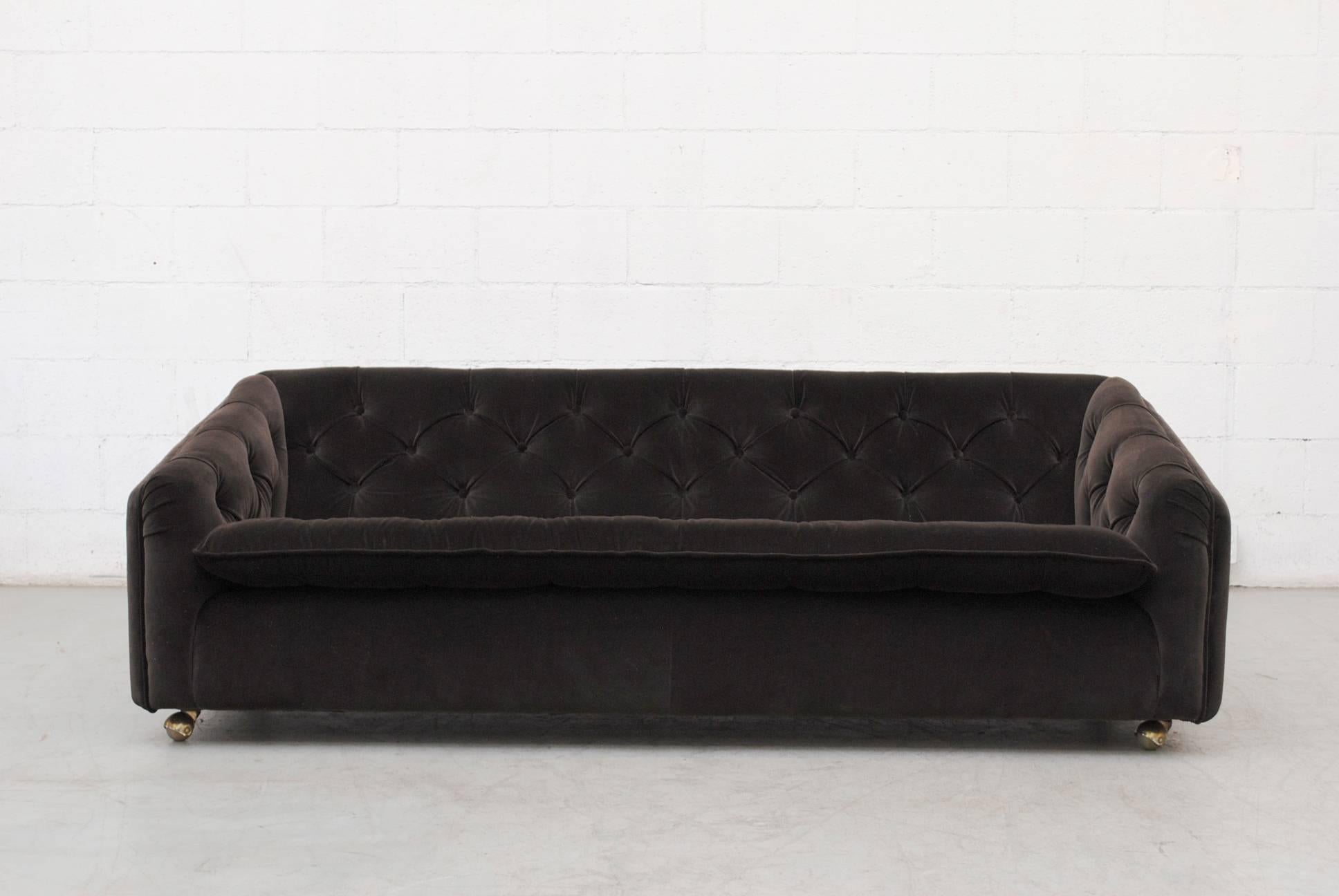 Three-seat sofa for Artifort newly upholstered in dark grey tufted velvet on four metal caster wheels. Matching lounge chair available. Sold separately.