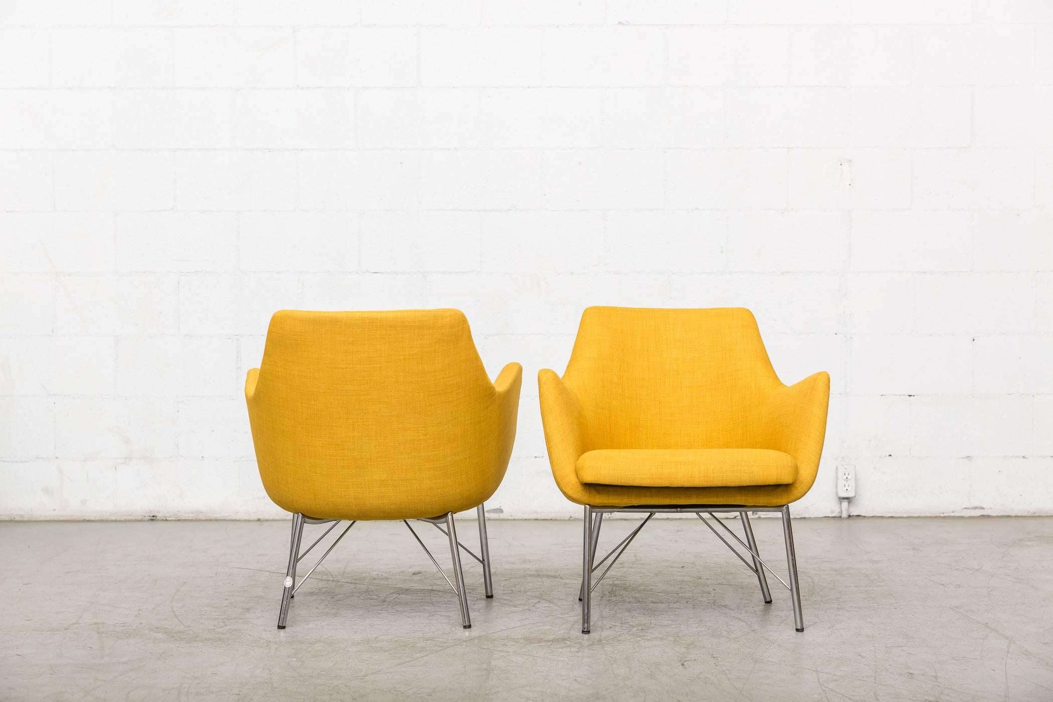 Pair of Ekselius for Pastoe lounge chairs newly re-upholstered in mustard yellow upholstery with original architectural chrome base. Frames are original with some signs of wear consistent with age and use. Set price.