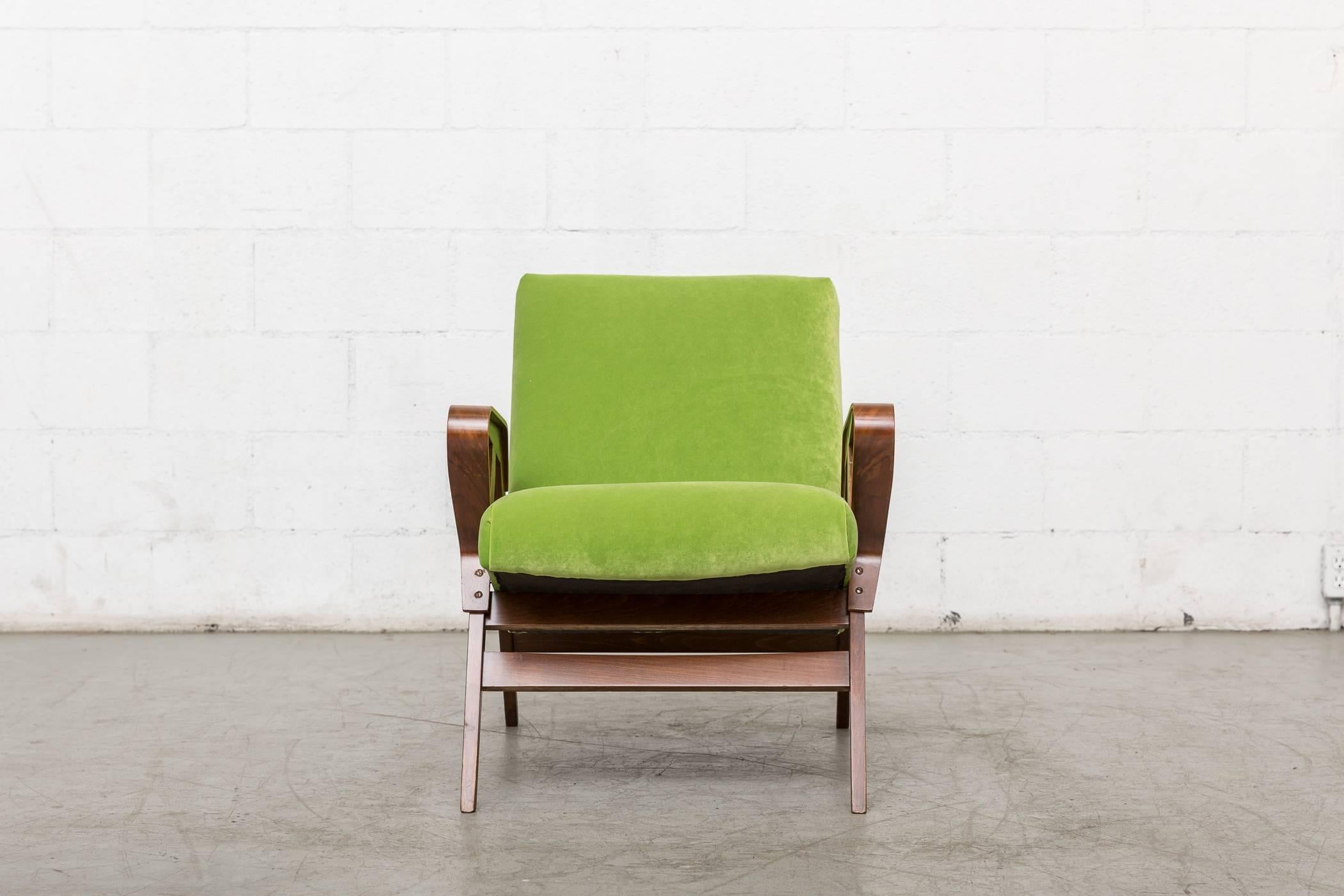 Gorgeous Tatra lounge chair with bent stained wood frame. Elegantly curved arm rests, 1960s Czechoslovakia. Newly upholstered in granny apple green velvet. Frame in good original condition. Others available. Listed separately.