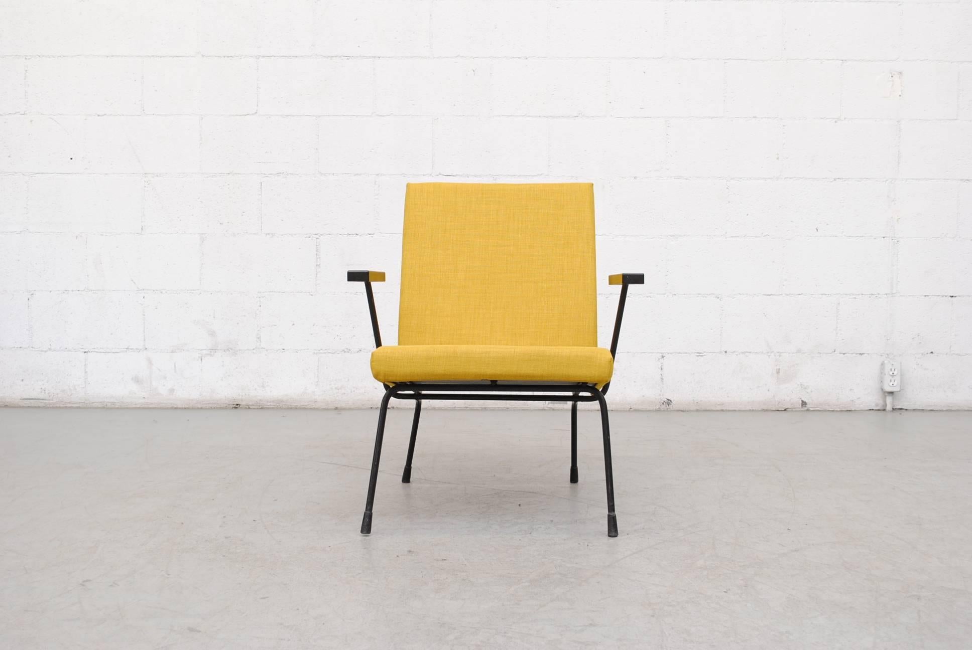 Pair of Wim Rietveld chair no. 1407 lounge chairs for Gispen with new sunshine yellow upholstery. Black enameled metal frames and black bakelite armrests. Frames in original Condition with some signs of wear. Set price.