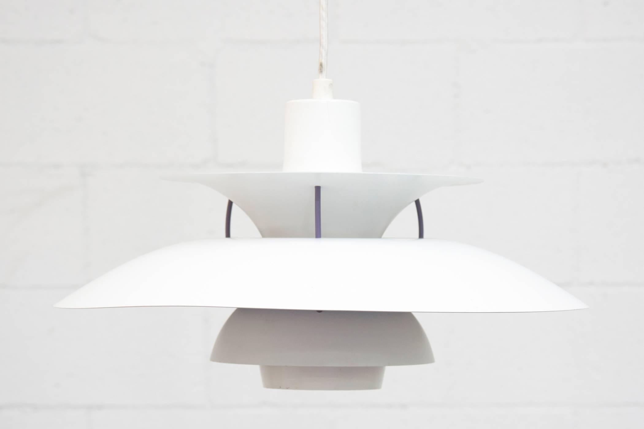 Designed in 1958 by Poul Henningsen as a versatile light fixture. The multiple shade design allows light to be channeled downwards and lengthen sideways. Bone white spun aluminum with violet accent. Original condition, some wear, minimal paint loss.