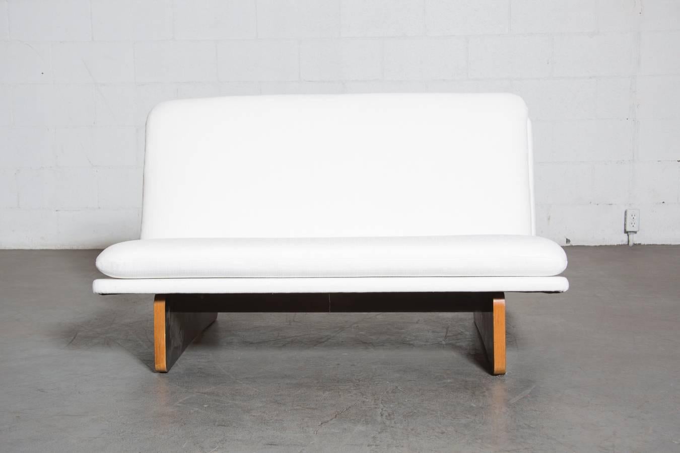 Newly Re-upholstered Little Bright White Kho Liang Le Loveseat with Rare Black Laminated Plywood Base. Base is Original and shows light scratching to Black Laminate and Wood Consistent with Age and Use.