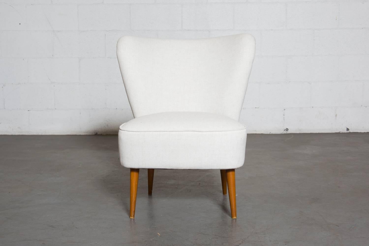 Theo Ruth Armless Boudoir Chair, Smaller in Stature. Newly Upholstered in White, Legs in Original Condition with Some Wear Consistent with Age and Use. 

Theo Ruth was an interior and furniture designer whose most famous design was his 1952 Congo