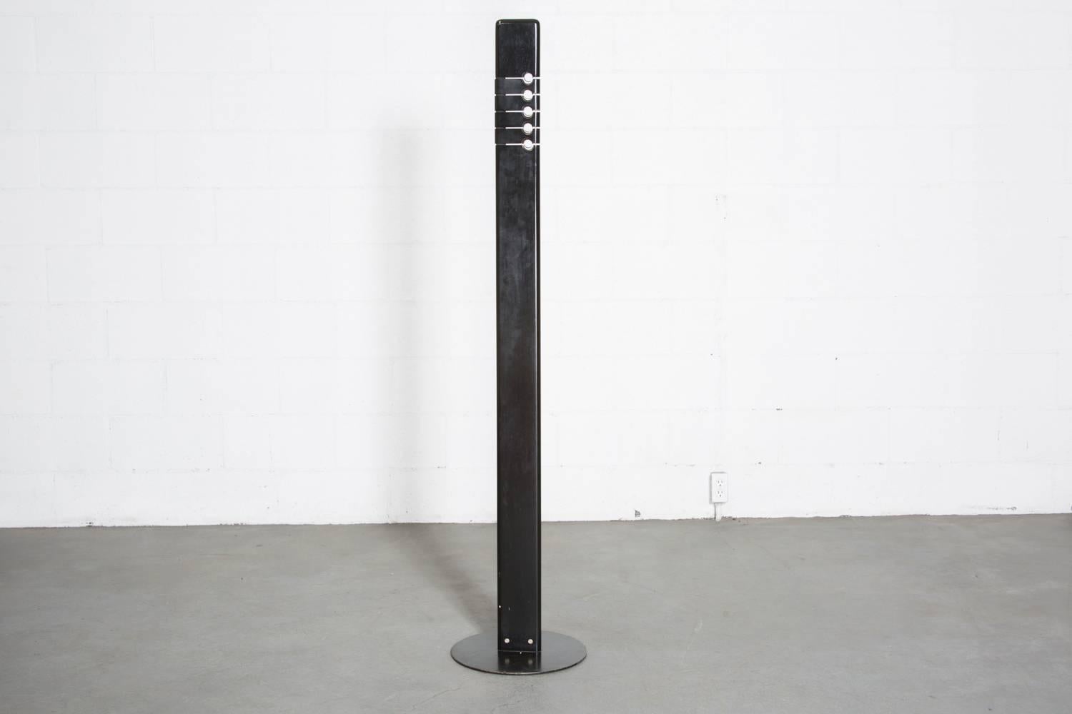 Italian designed ebonized wood plank coat stand with enameled steel base and chrome hooks. Unique operating design. Original worn condition.