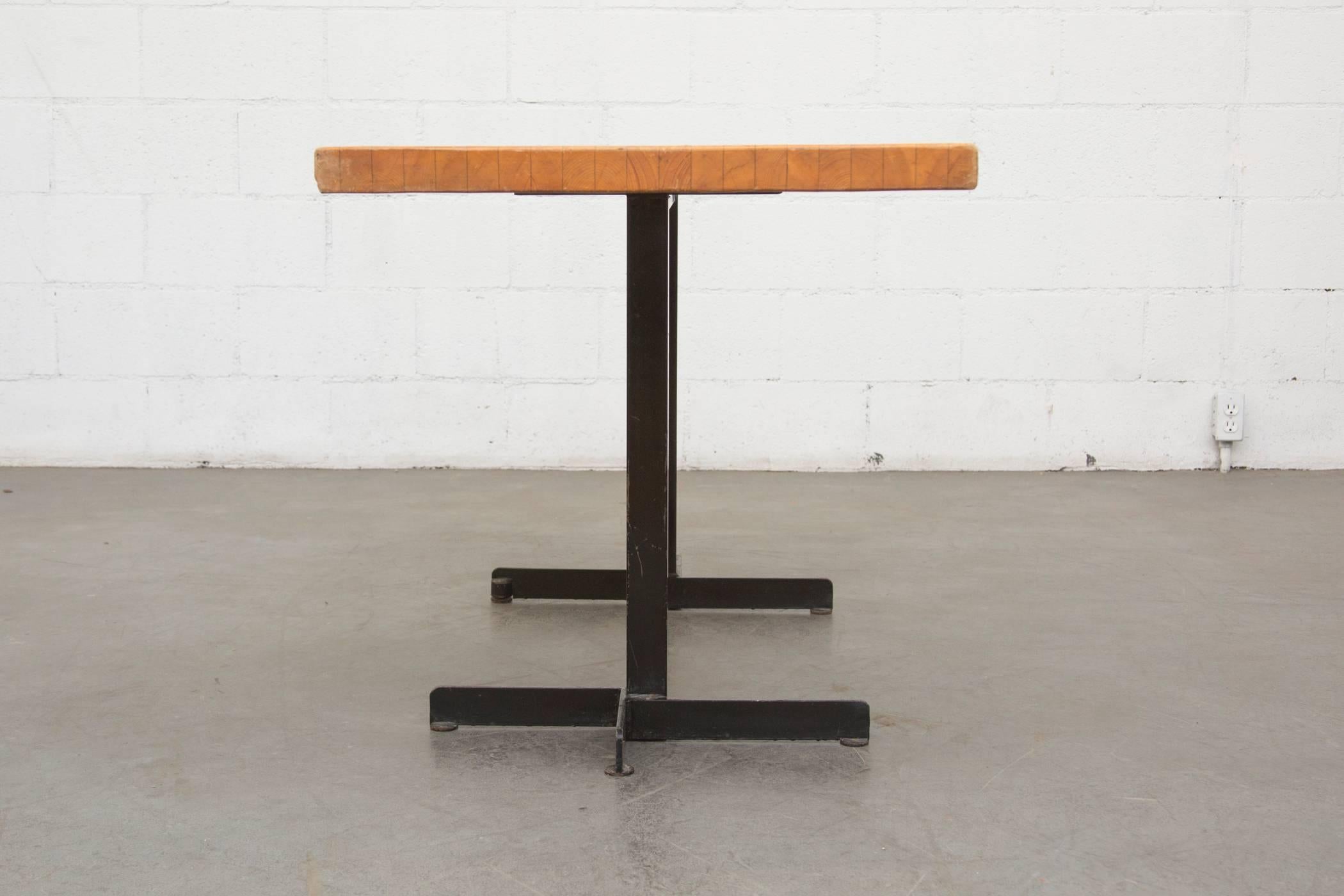 Solid pine dining table by Charlotte Perriand for Les Arcs Ski Resort, France. Black enameled metal geometric base. In original condition with visible wear to corners and edges of table top and wear to enamel on frame consistent with age and use.
