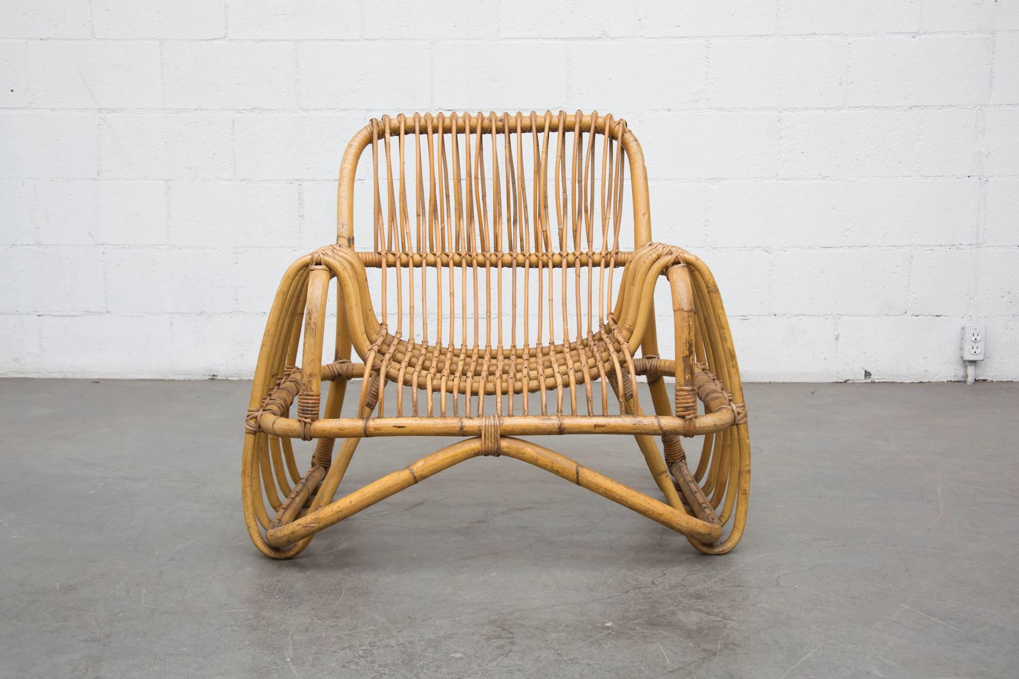 Impressive bent bamboo lounge chair in the style of Franco Albini. In original condition with some wear and sun discoloration consistent with age and use.