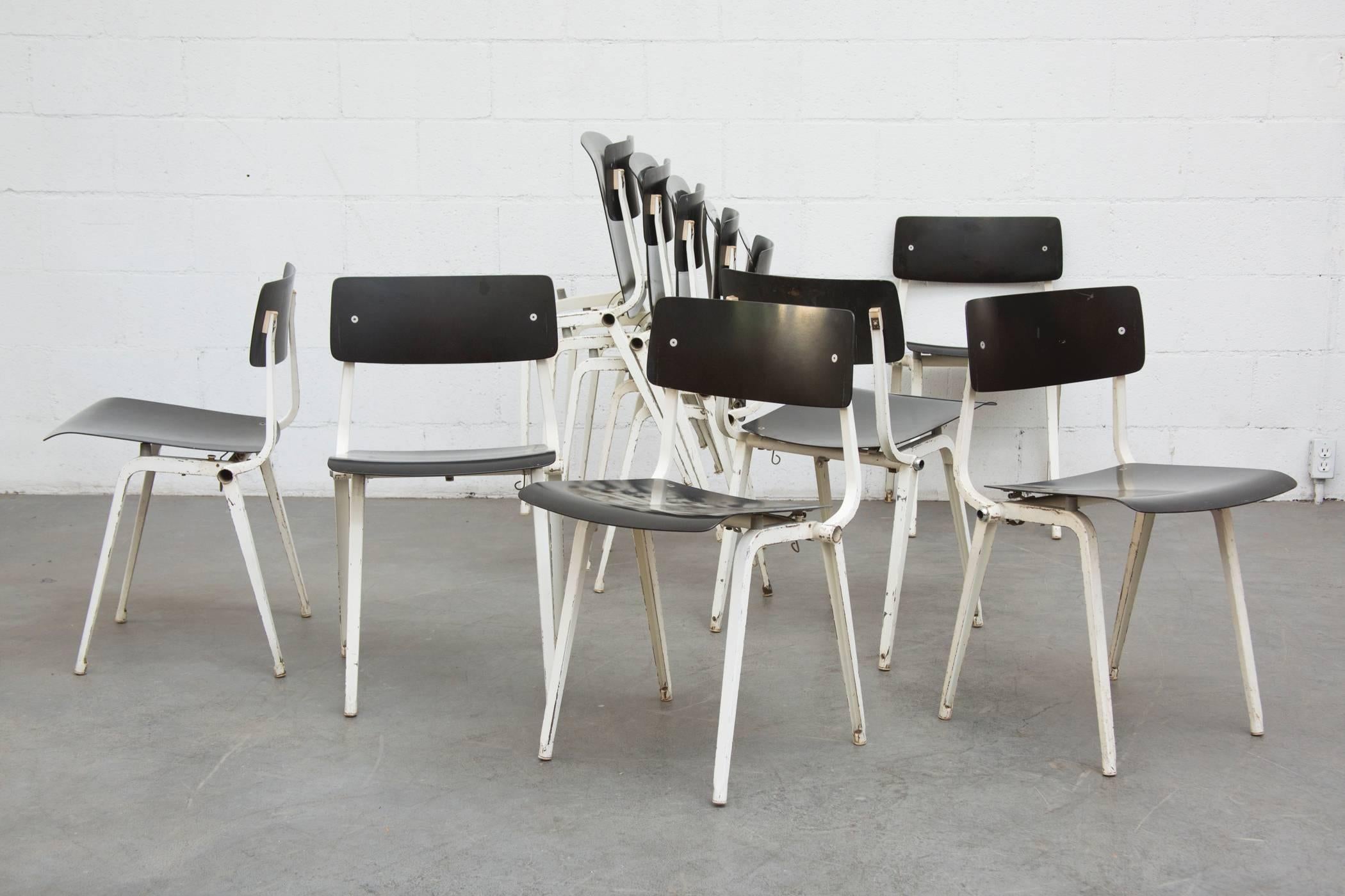 Designed in 1959 and only produced for four years, the Friso Kramer theater chairs are very rare. They fold and can be stacked. White enameled sheet metal frame and molded acrylic seat and back. In very original condition with some surface rust and