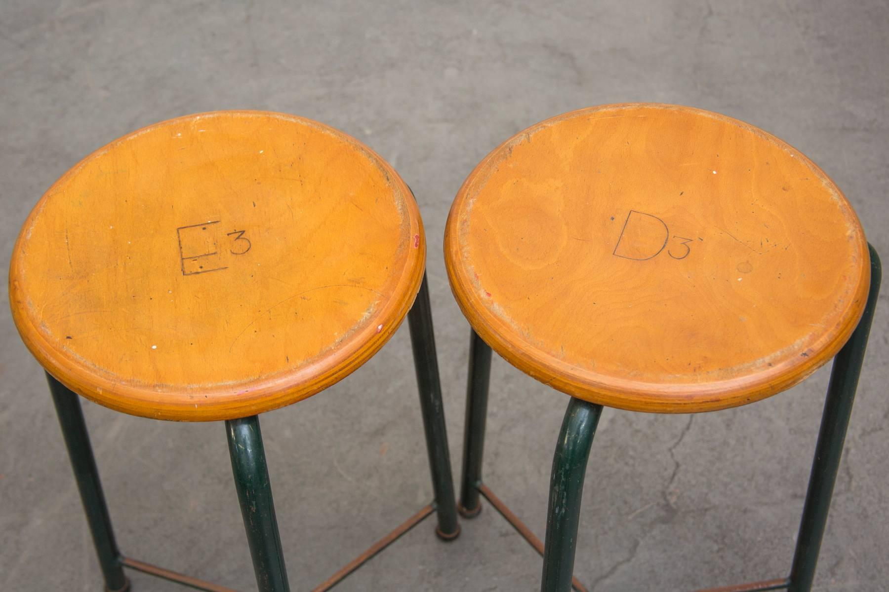 Amazing pair of science lab stools with engraved solid birch tops and original enameled metal tripod bases, some wear to enamel. Original condition, set price.