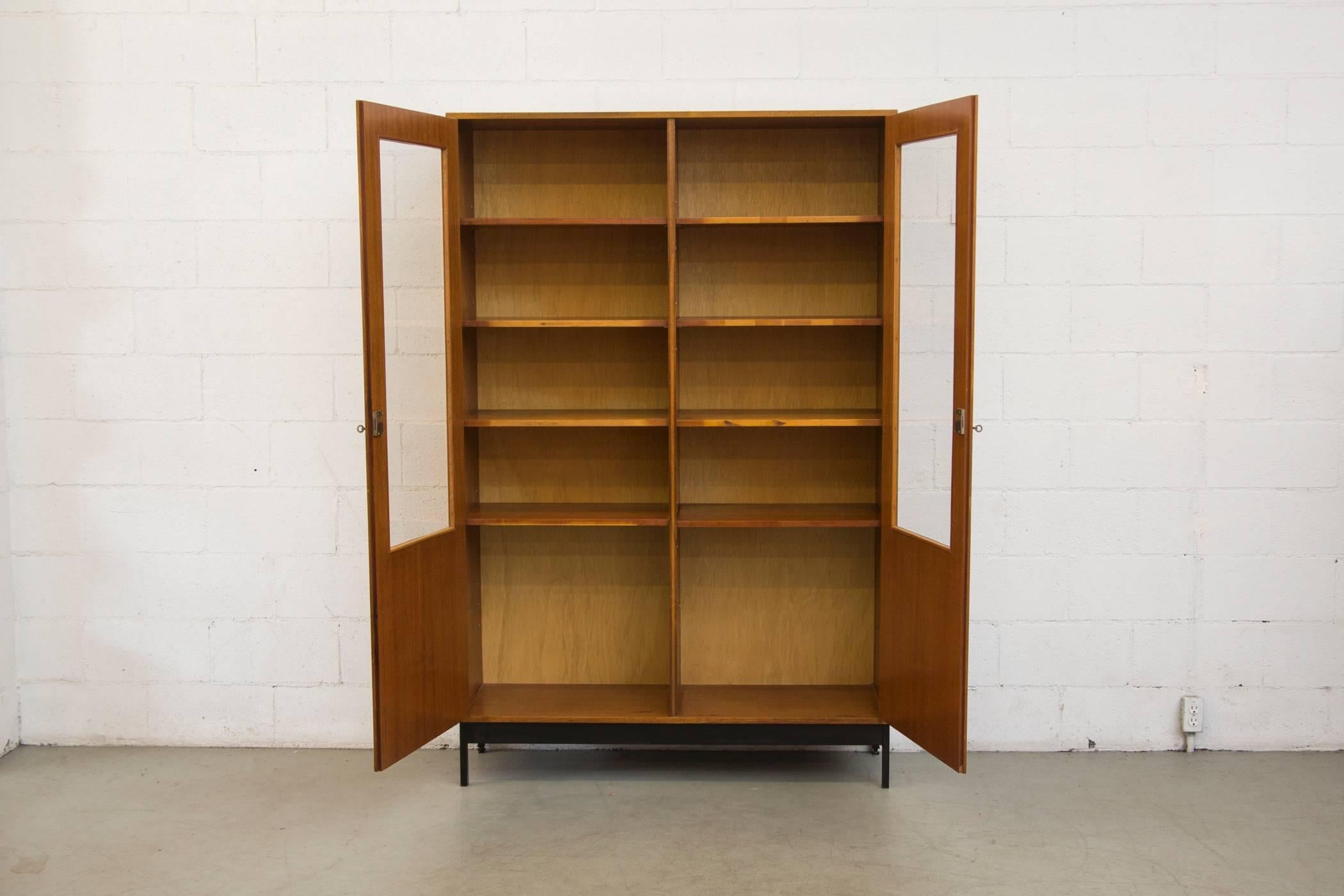Amazing display cabinet, China cabinet, office book shelf! Bleached mahogany case with double glass doors, adjustable height shelves on a steel frame. Original condition with minimal wear consistent with its age and usage. Extra shelves available