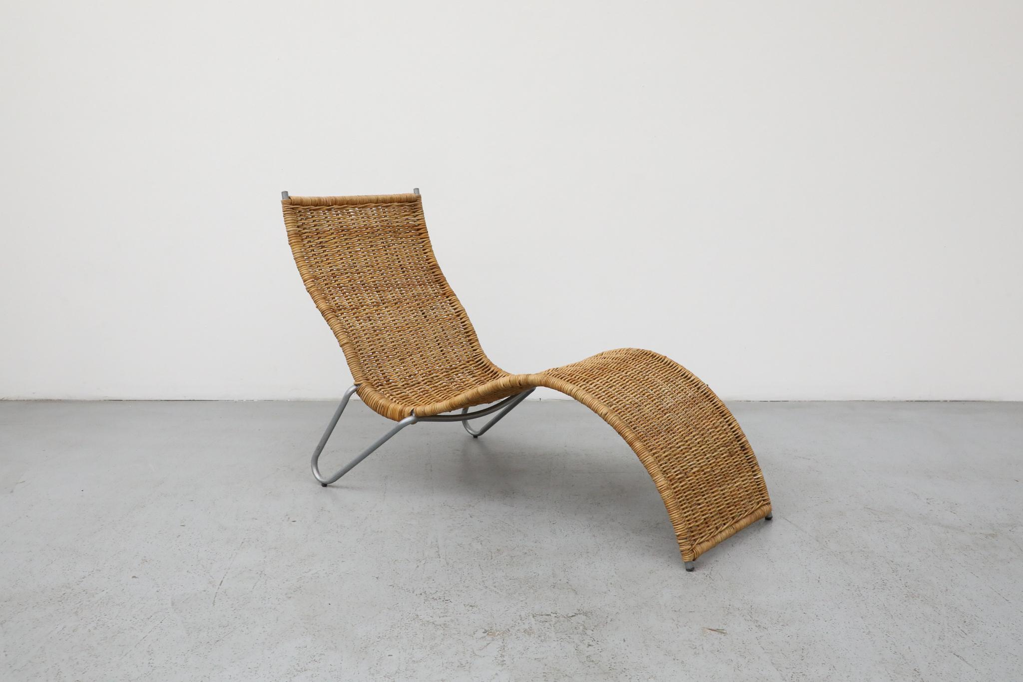 A striking contemporary rattan chaise designed by Karl Malmvall of Sweden in 2005. This piece draws clear inspiration from the airy, organic forms and woven materials characteristic of Dirk van Sliedregt's Mid-Century designs, creating a chaise that