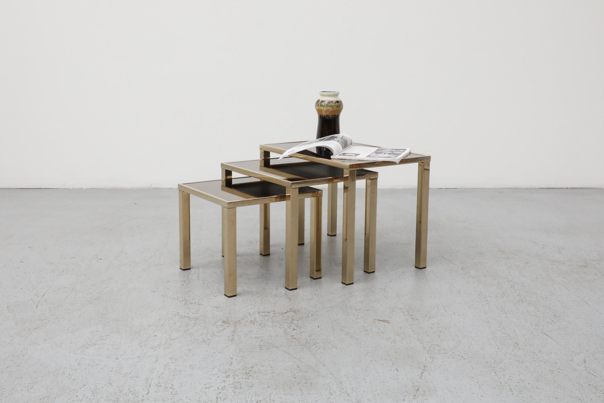 SA stunning set of three Belgian Mid-Century nesting tables, manufactured by Belgo Chrom in the 1970s. These tables, crafted in the distinctive style of Guy Lefevre, embody the opulent 