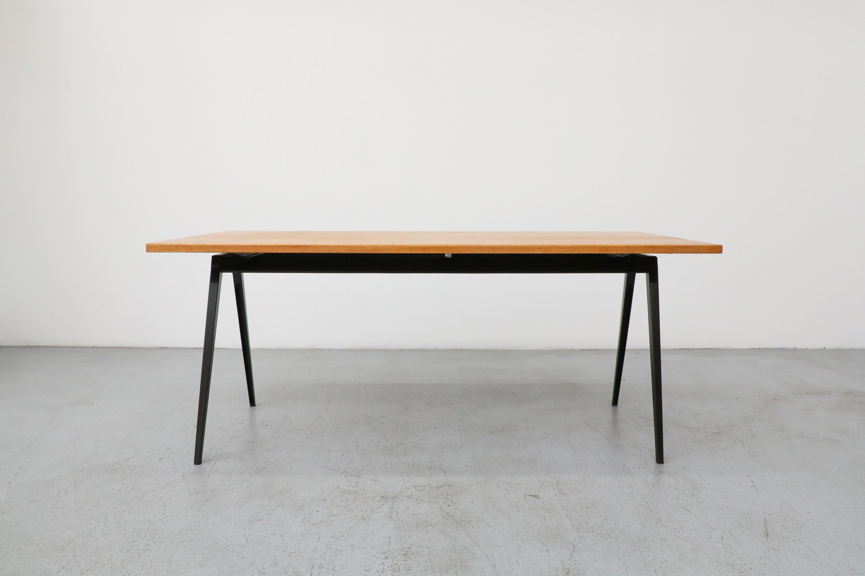 A striking and highly functional Mid-Century dining or conference table, designed in the enduring style of Jean Prouvé. This piece embodies the functionalist aesthetic and industrial elegance characteristic of mid-20th century modernism.

The table