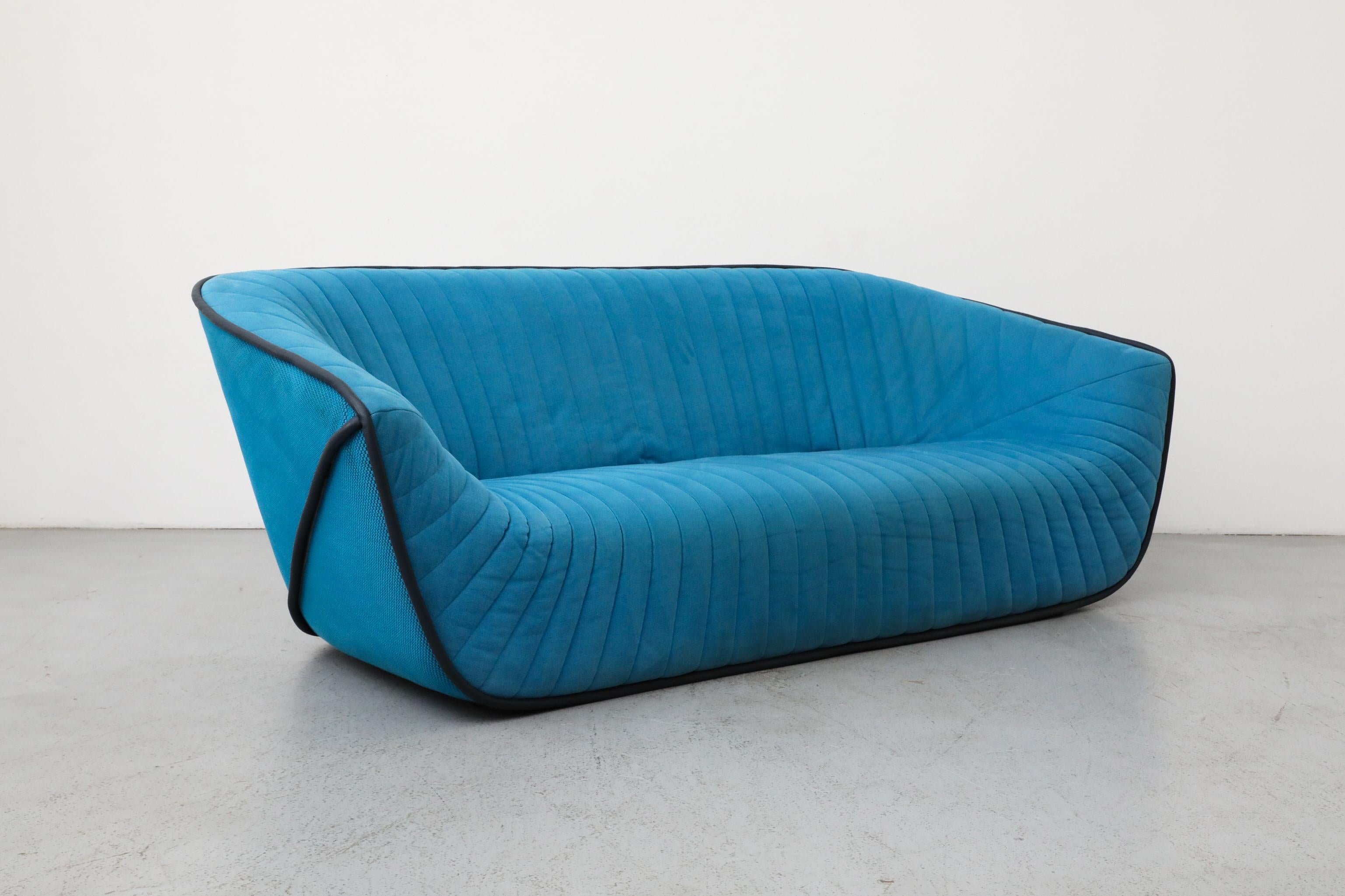 Designed by acclaimed French industrial designer Cédric Ragot for Roche Bobois in 2013, this sculptural three-seater sofa blends contemporary form with luxurious materials. Known for his innovative and fluid designs, Ragot created a piece that is