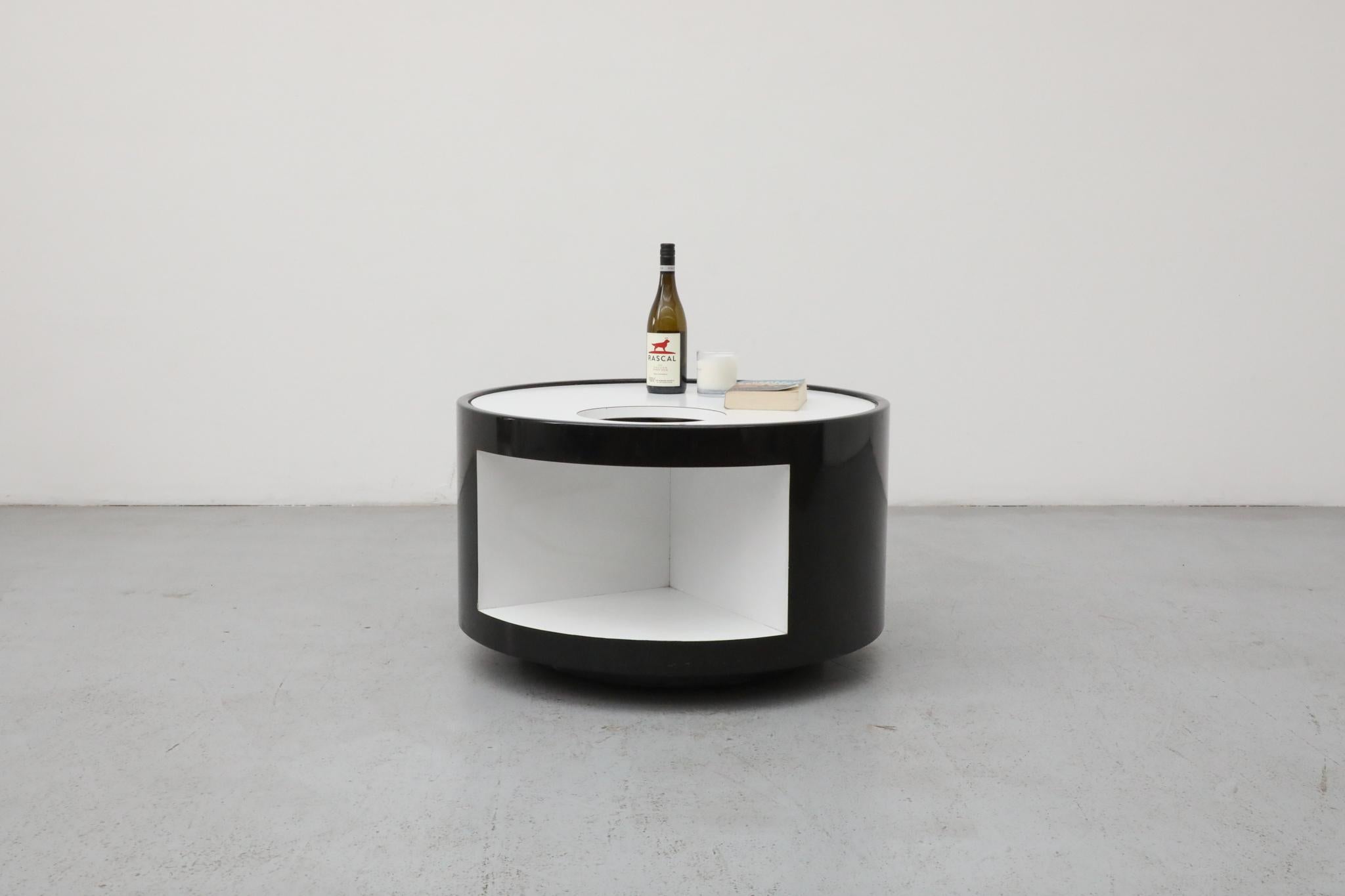 A striking black and white rolling bar cart from the Italian Space Age period, dating circa 1980s. Crafted from laminated wood and painted finishes, this piece is a testament to the era's innovative spirit and playful geometry.

This versatile cart