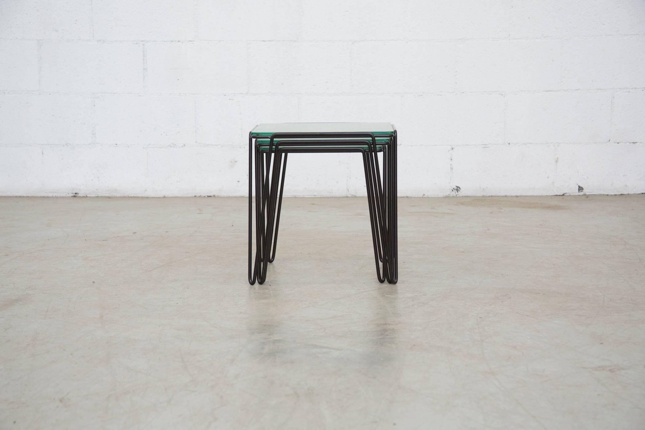 Rare set of three wire and glass nesting tables newly powder coated in black by A. Bueno de Mesquita with original patio glass. Glass shows signs of use and wear consistent with its age and usage. Set price.