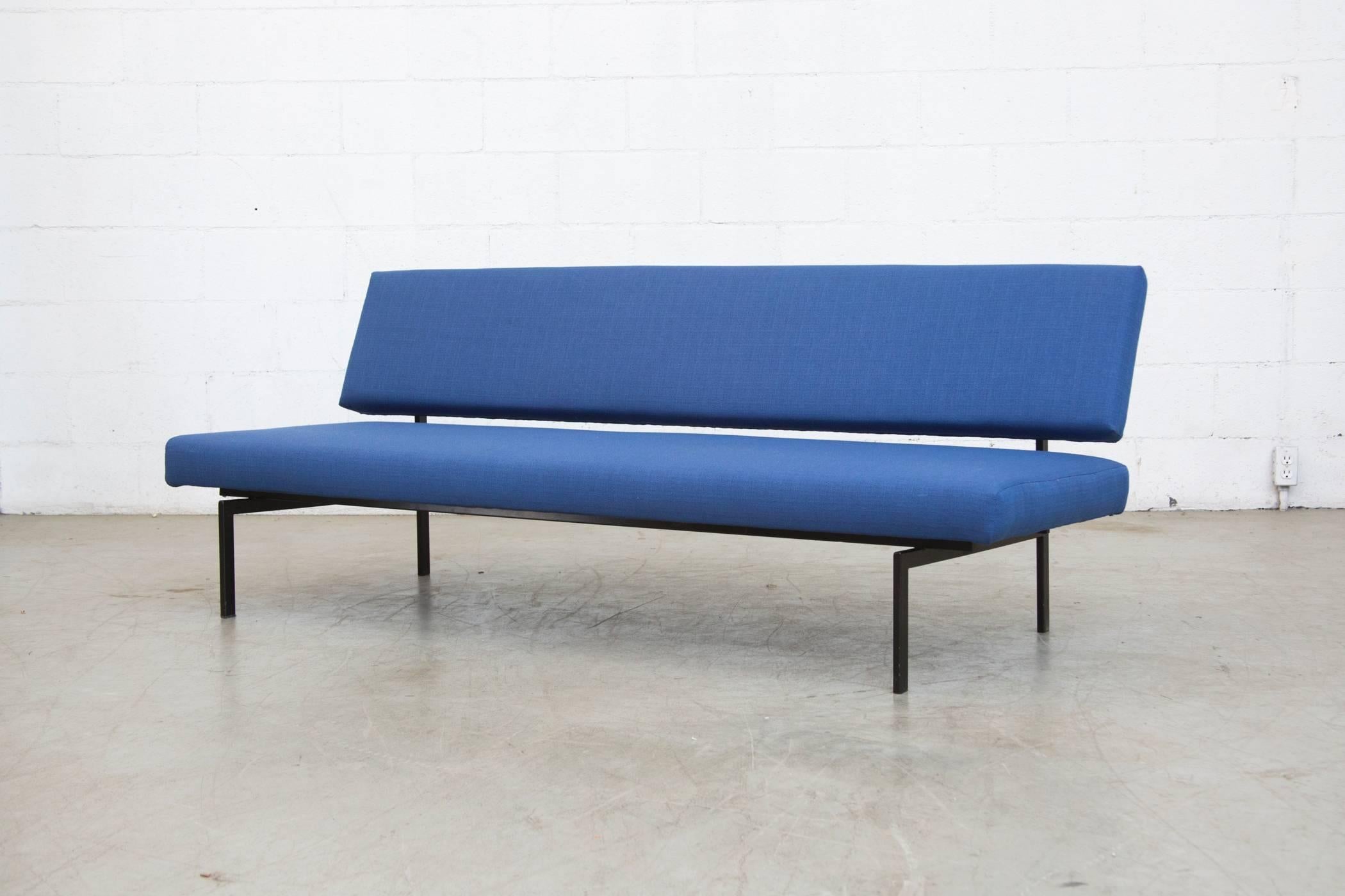 Super streamlined Mid-Century sofa newly upholstered in royal blue with black enameled metal frame. Square tubular enameled metal frame in original condition with visible signs of wear to the frame.