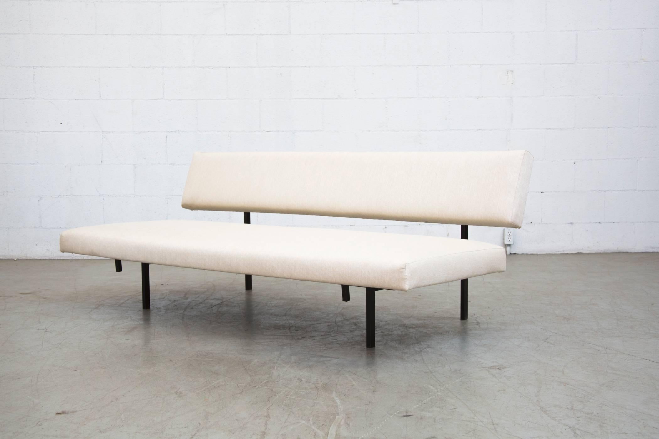 Bone white upholstered Martin Visser sleeper sofa with pull out bench that levels to a single bed for your guest. Frame in good original condition with wear consistent with age and use. When pulled out, seat opens to 36.5