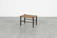 Taburete negro de estilo Charlotte Perriand de mediados de siglo, de origen holandés, con asiento de cuerda trenzada