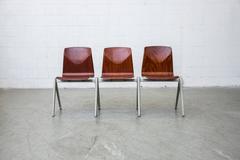 Set of 6 Prouve Style Red Teak Toned Industrial Stacking Chairs w/ Compass Legs