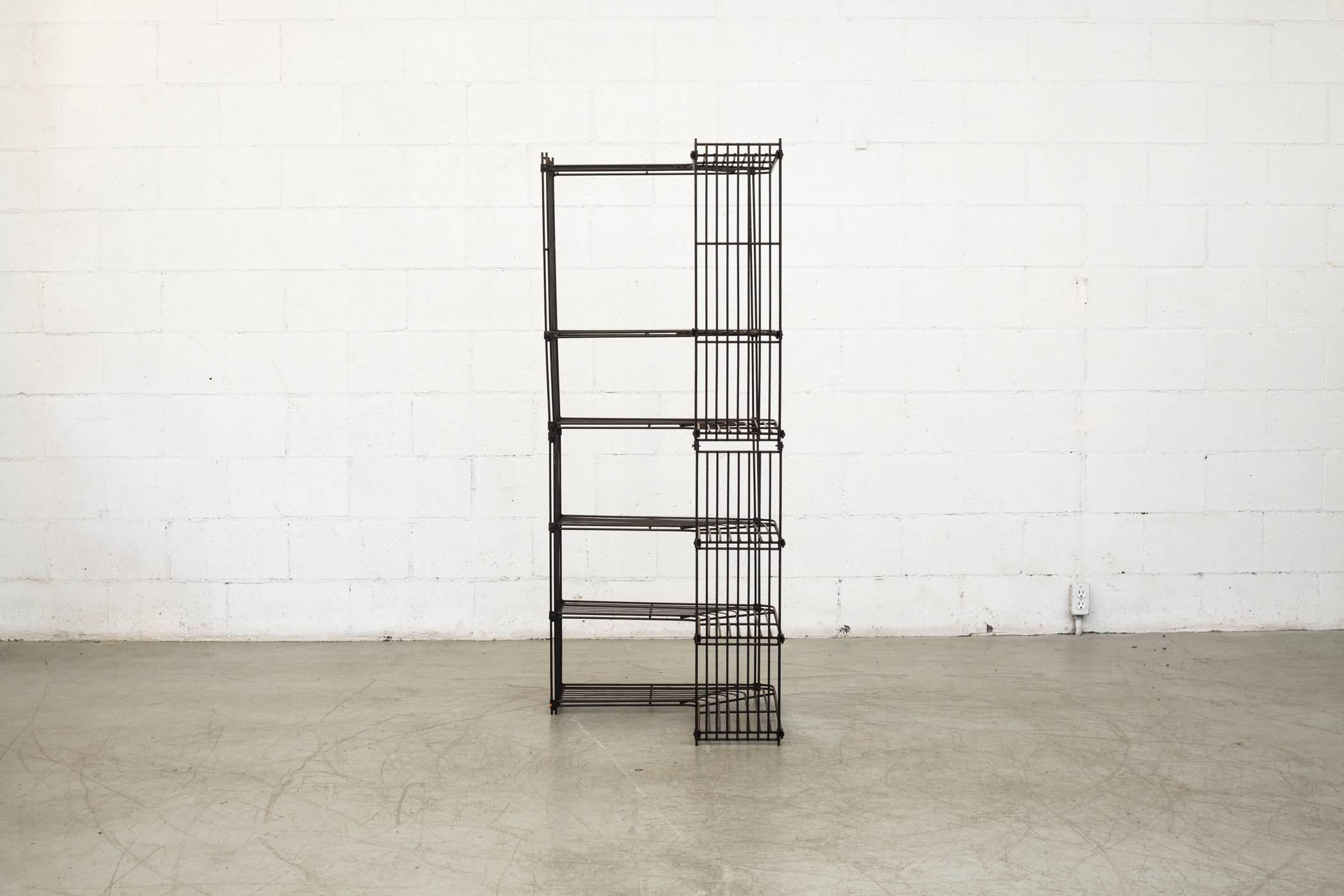 Very rare and very cool wire corner shelving unit designed by Dutch designer Tjerk Reijenga for Pilastro in the 1960s. Each side measures: 24.375 x 9 x 60.125 end to end 34.5. Very original condition, visible patina.

 