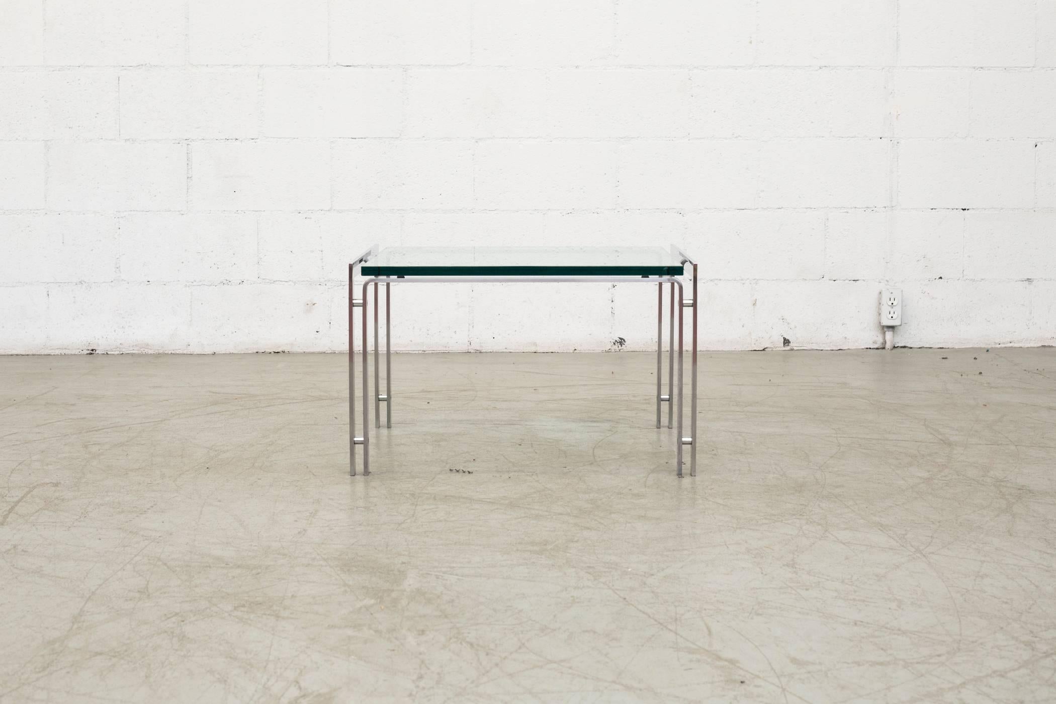 Handsome double banded metal framed side table with thick glass top. In original condition with visible signs of wear consistent of its age and usage. Other sizes available and listed separately.

 