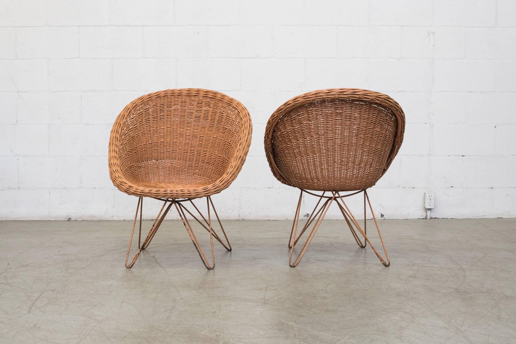 Incredible pair of woven rattan chairs in mauve with matching enameled mauve frame in the style of Jacques Adnet. Visible wear and use consistent with their age.

 