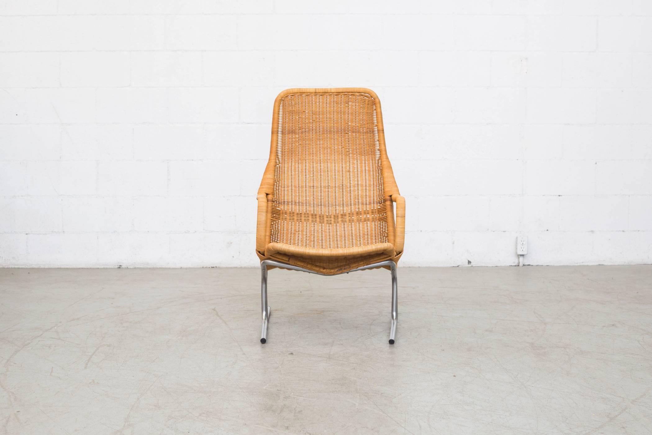 Awesome woven rattan lounge chair with chrome tubular metal frame with woven rattan seat. Some color variations in rattan weave. Original condition with minimal rattan loss.

